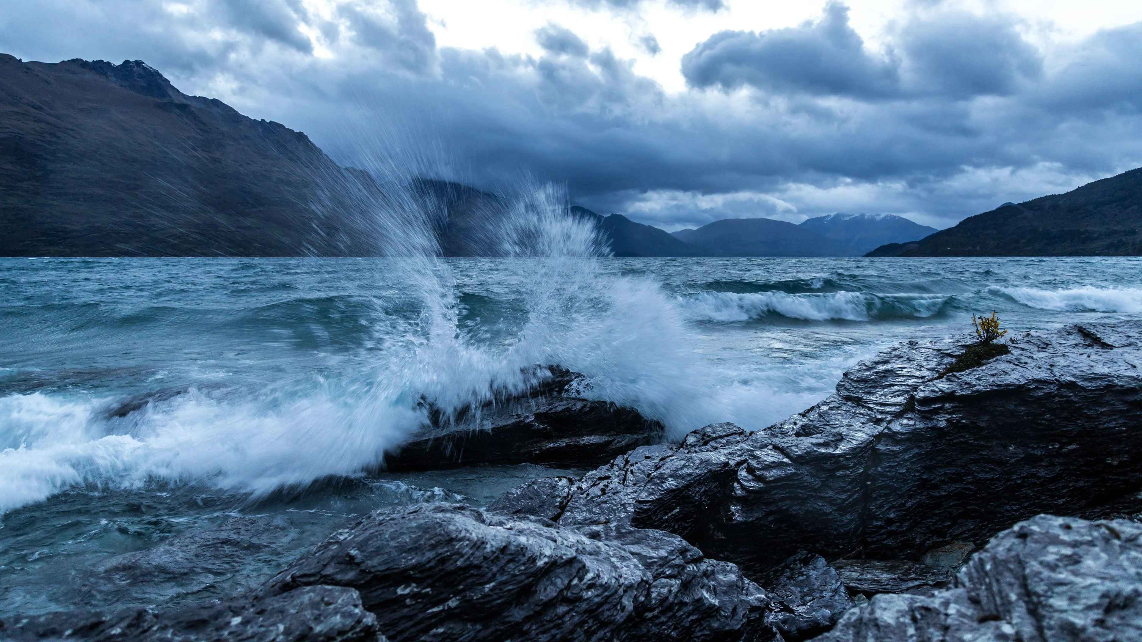 Waves Crashing on a Rocky Shore Under a Dramatic Cloudy Sky