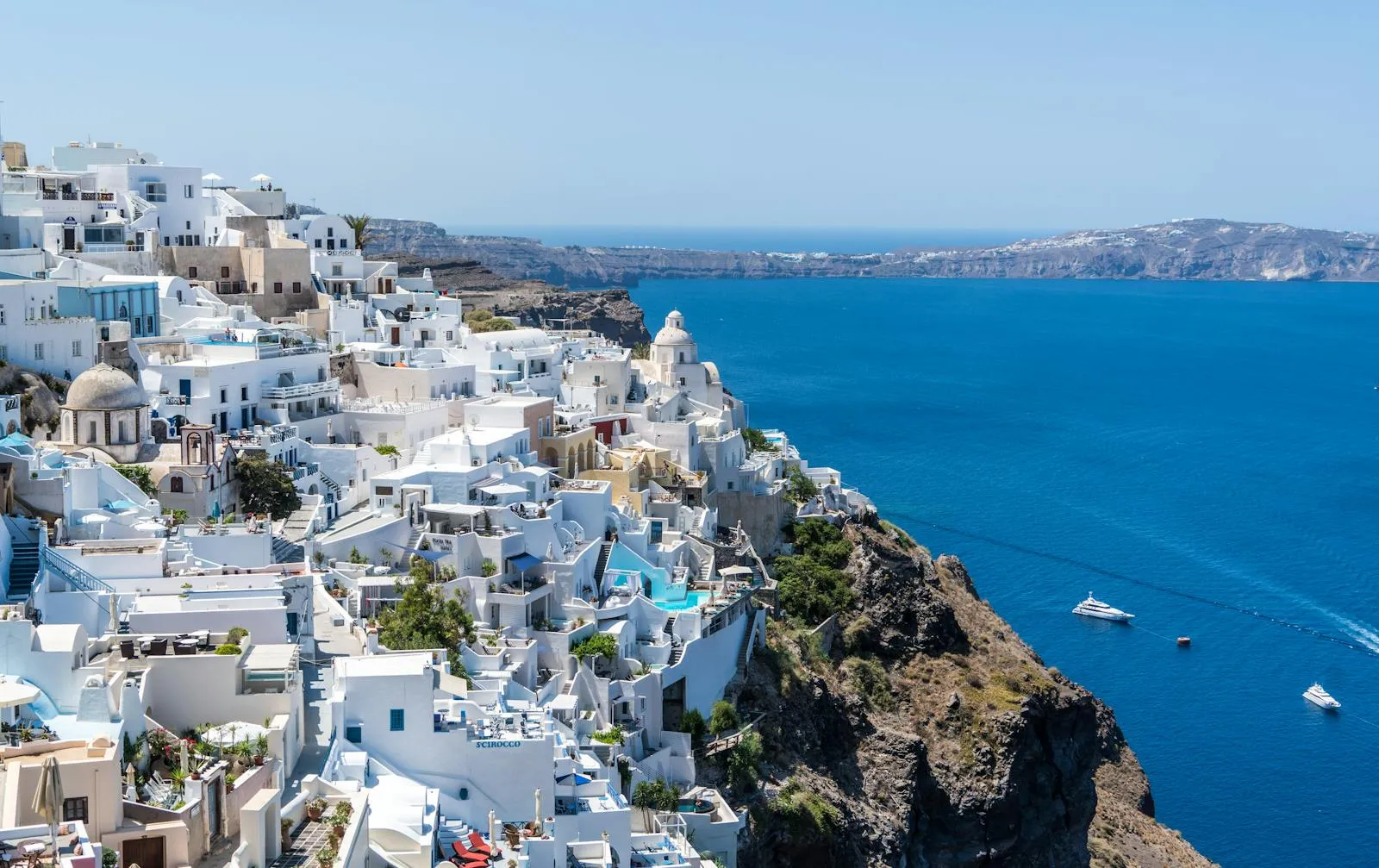 White Buildings on the Cliffside with Deep Blue Ocean