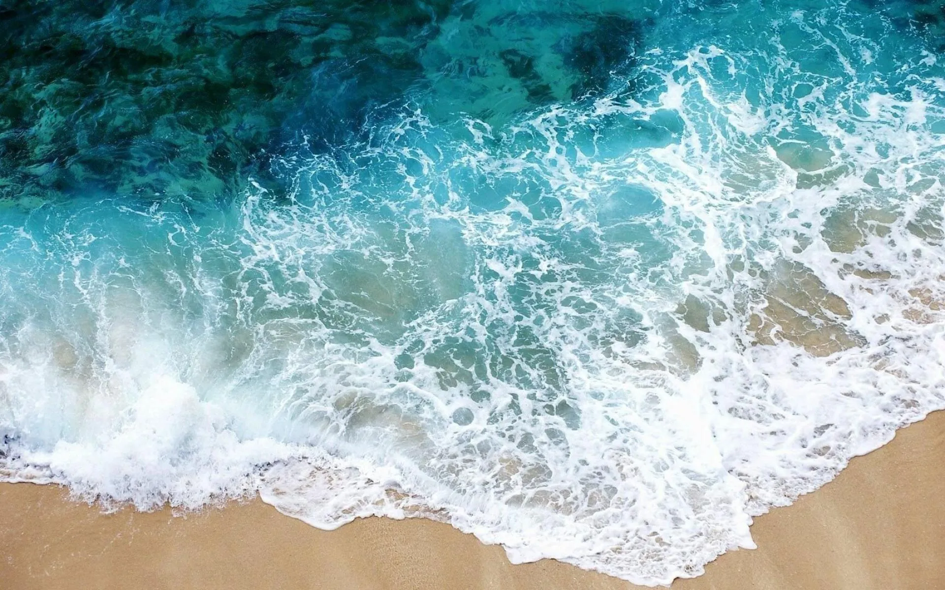 White Foamy Waves Gently Hitting a Sandy Tropical Beach