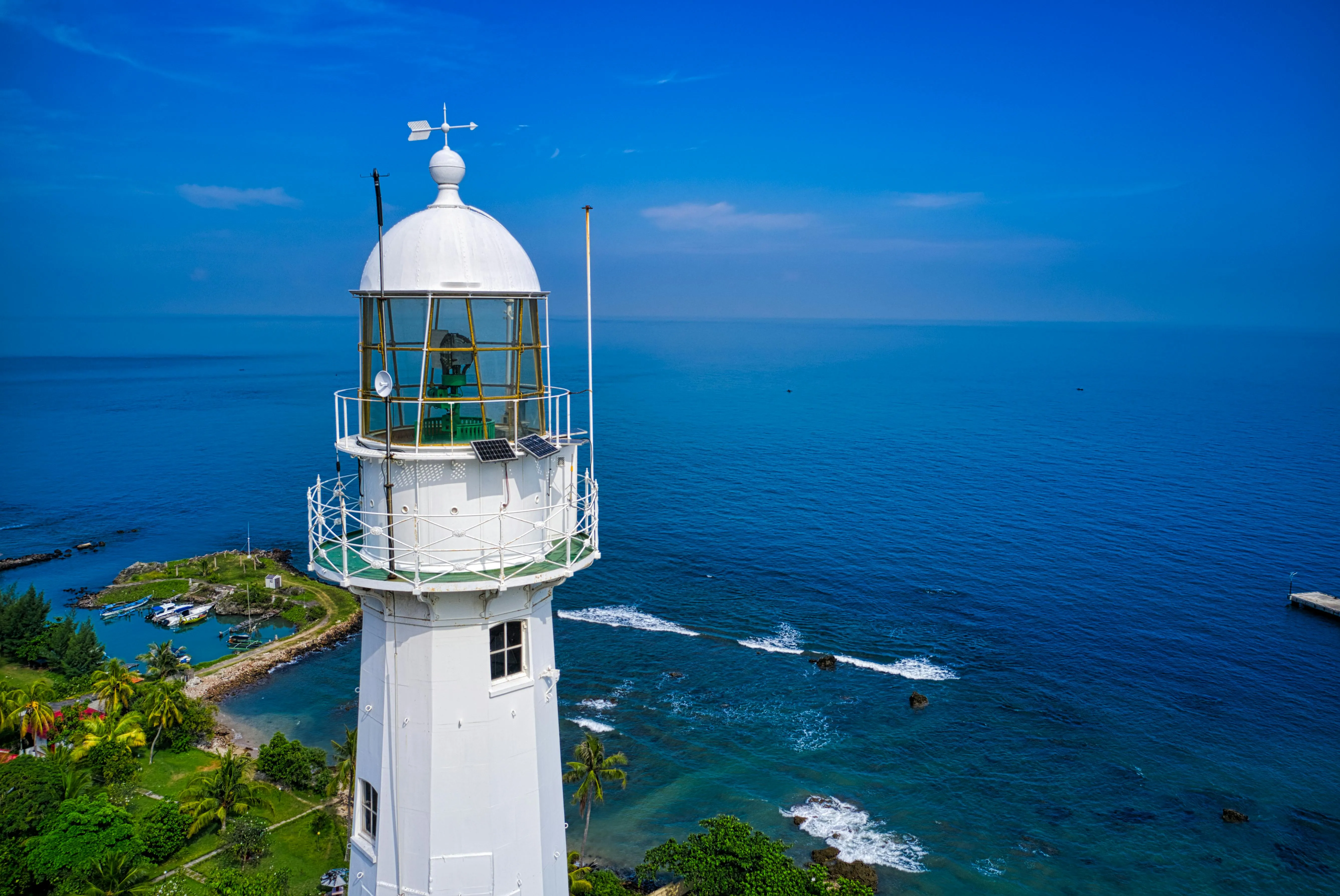 White Lighthouse Close View with the Blue Ocean Wallpaper