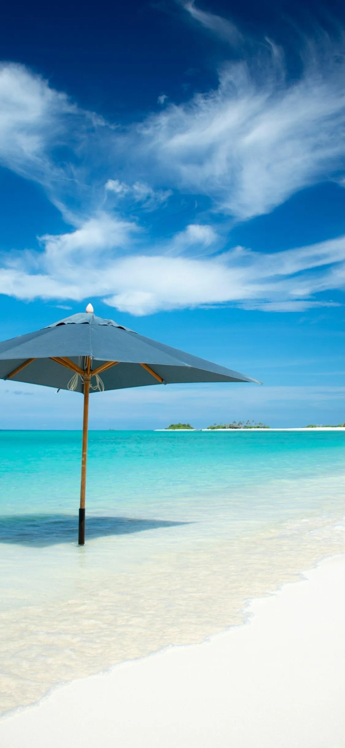 White Sandy Beach with Umbrella Under Bright Sunny Sky