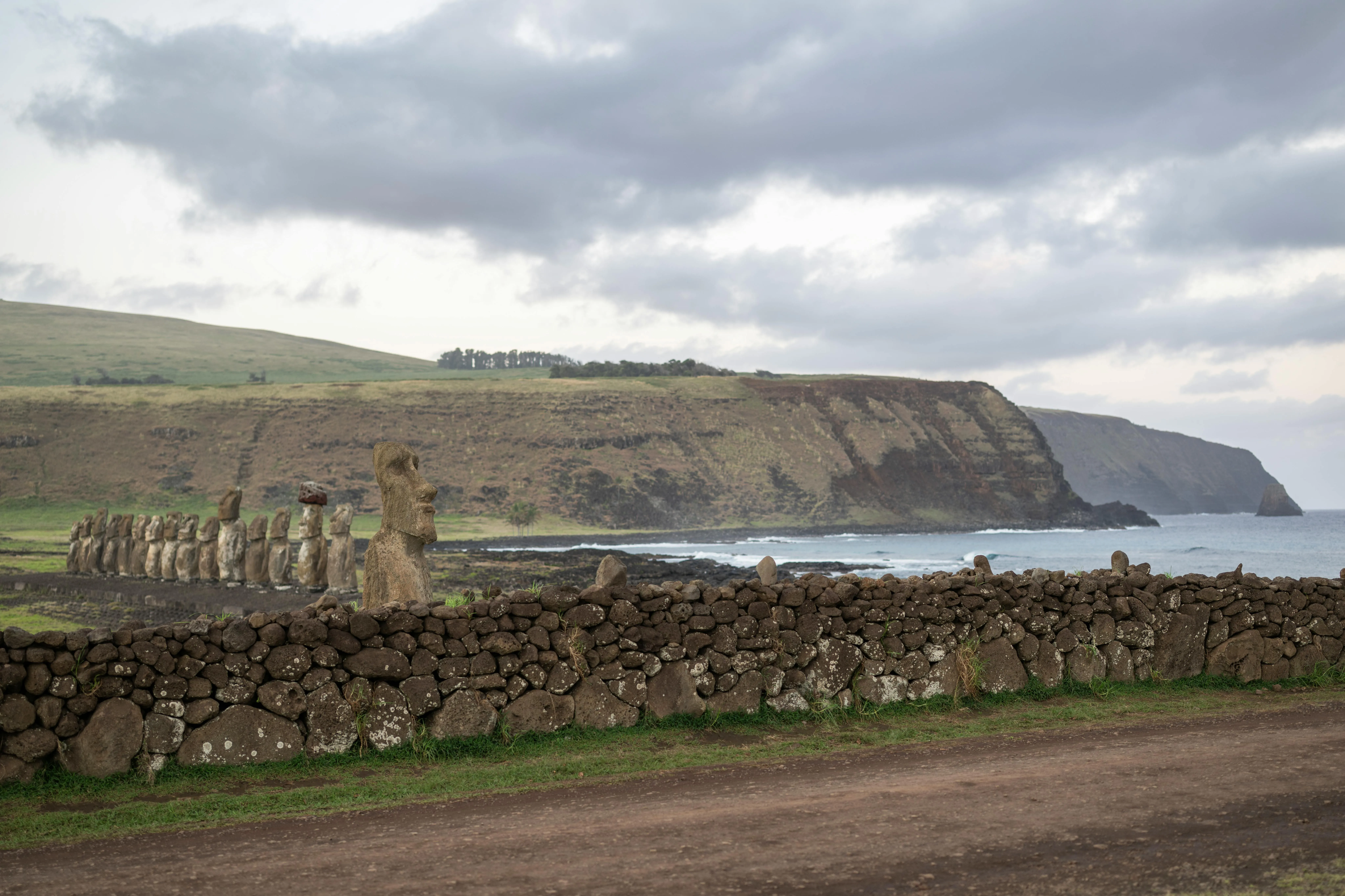 Wide Landscape with a Grassy Field and Cliffs Free Wallpaper