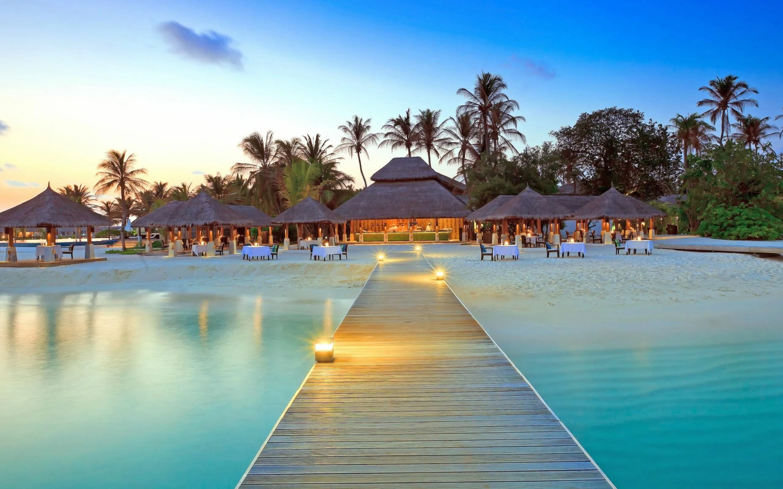 Wooden Pier Stretching Out to the Beach Resort Wallpaper