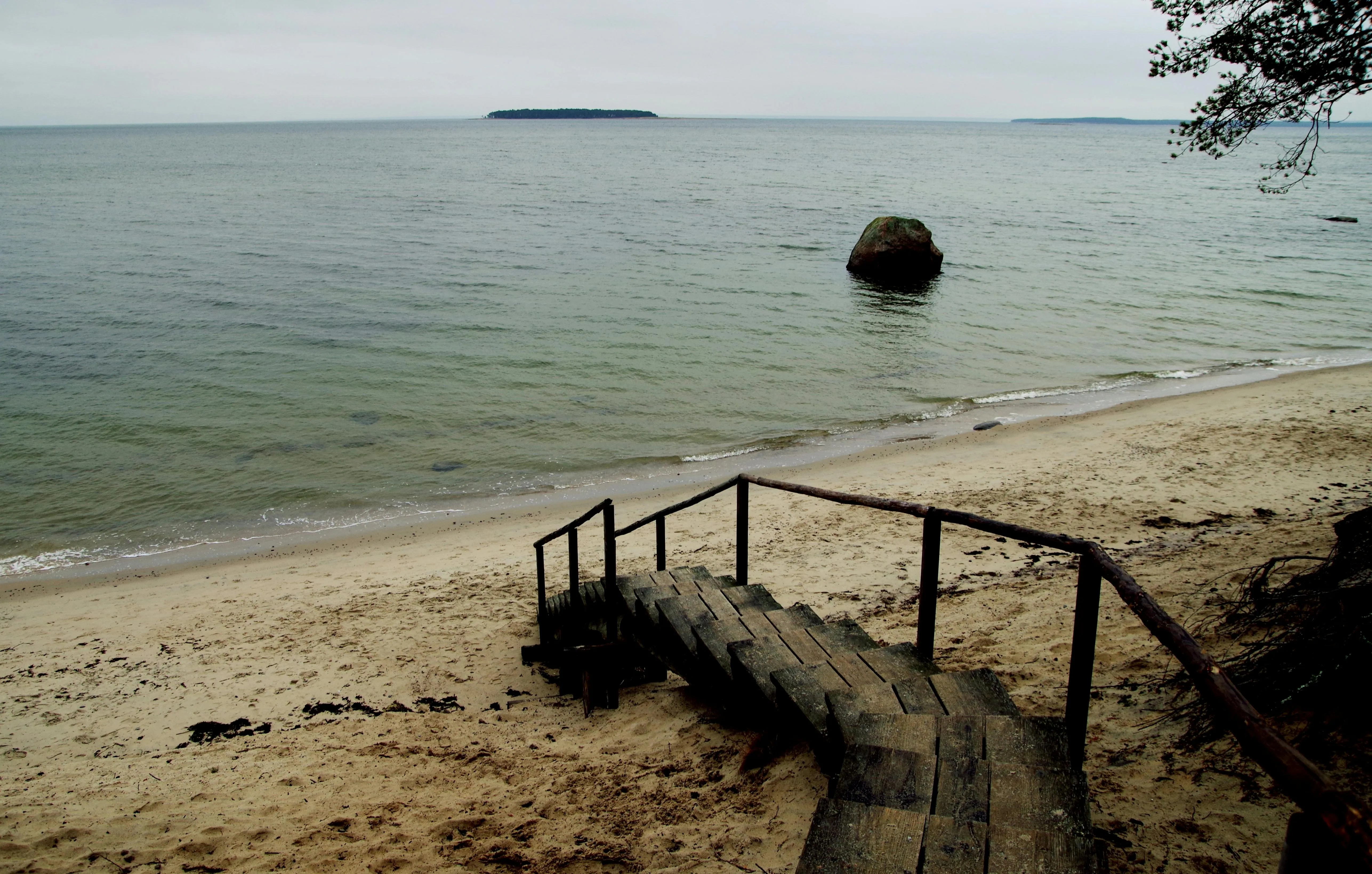 Wooden Steps Lead to a Quiet and Empty Beach Free Wallpaper