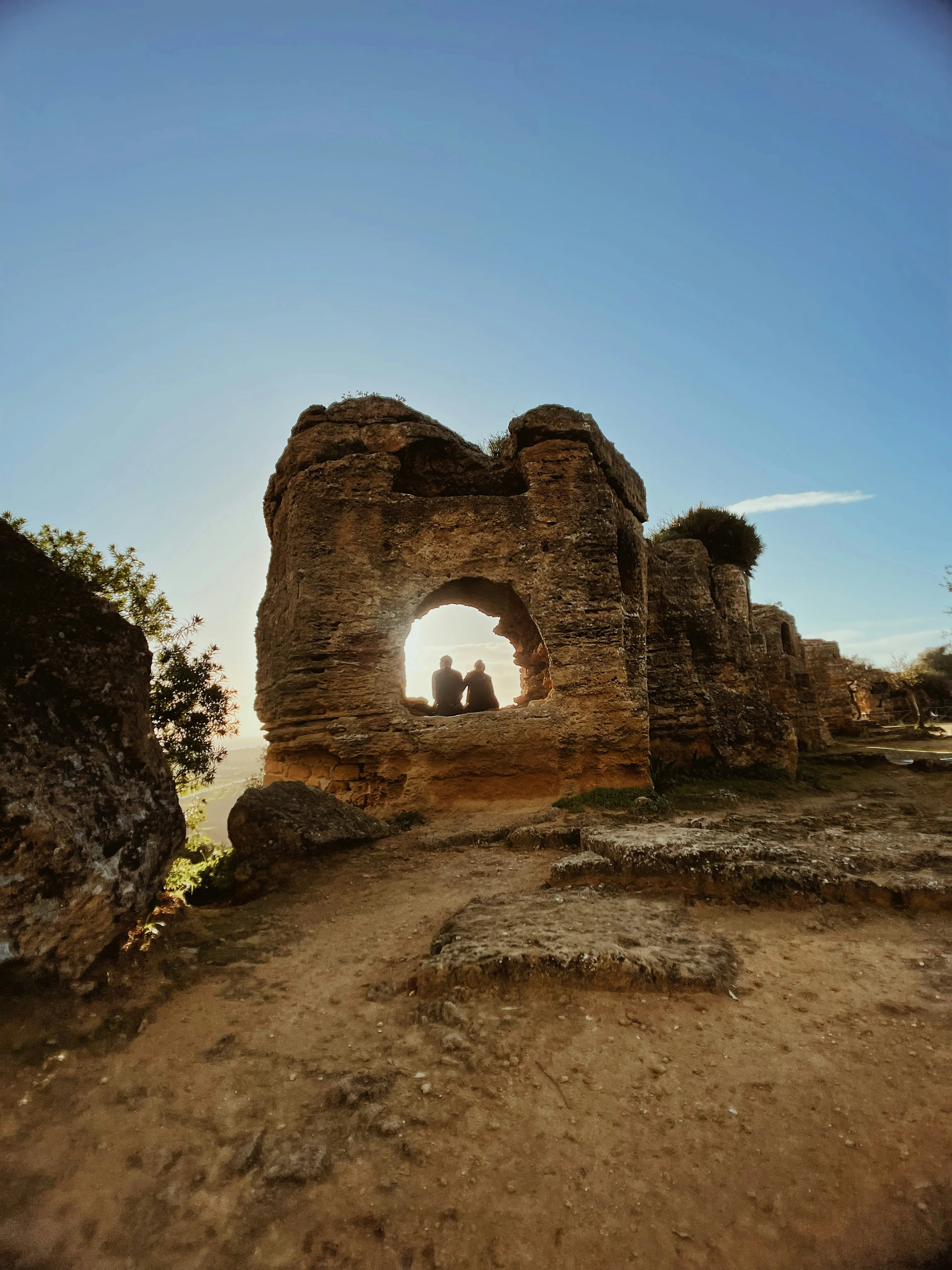 Ancient Stone Archway Under Clear Blue Sky Wallpaper