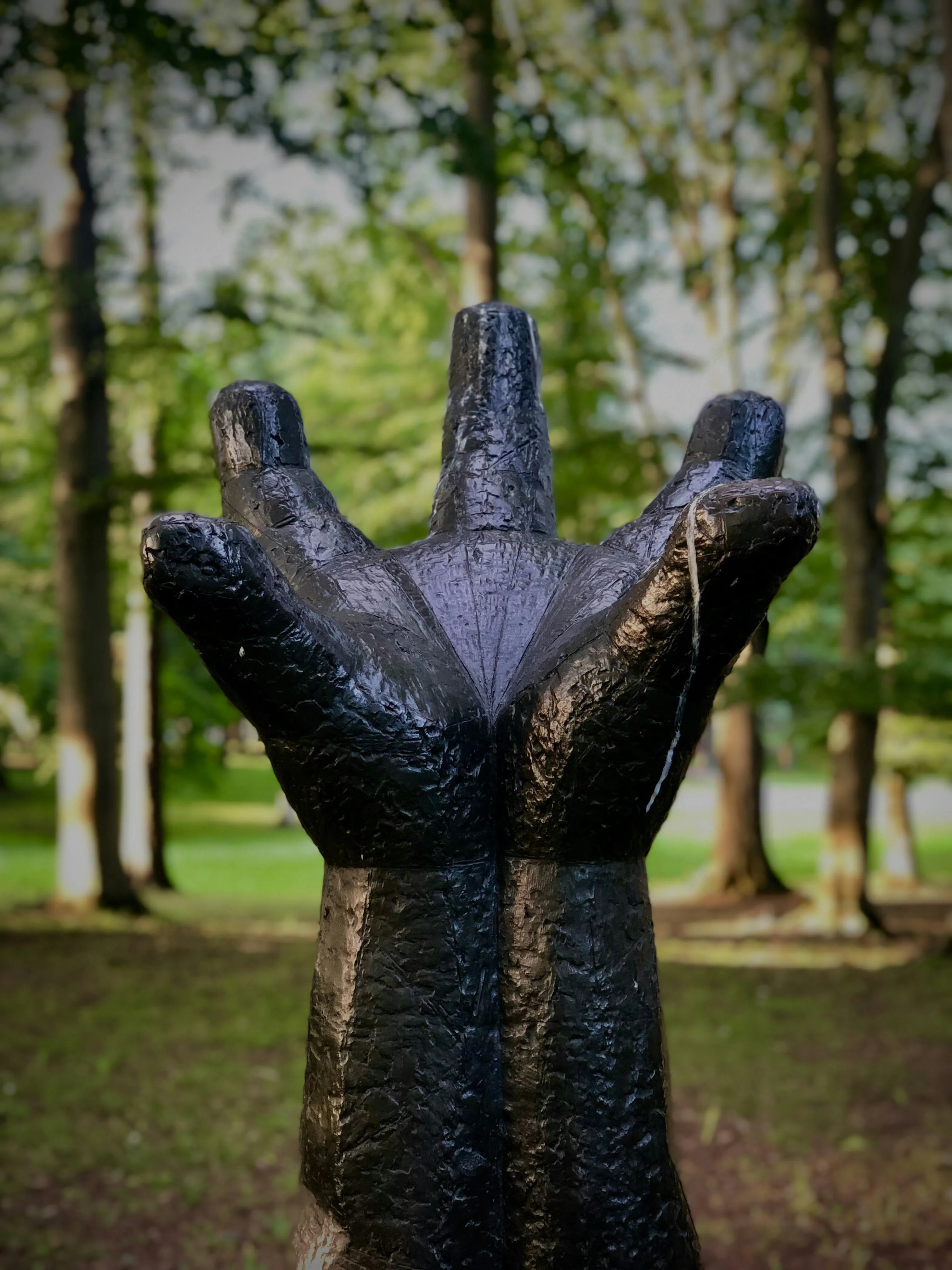 Artistic Hand Sculpture in Outdoor Garden View Wallpaper