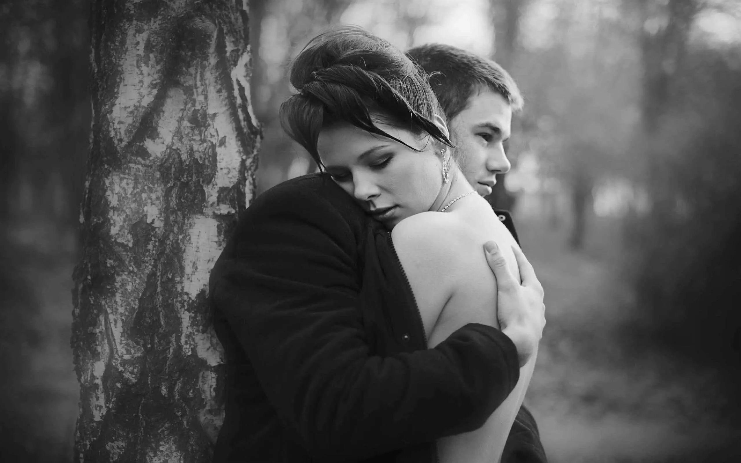 Black and White Couple Hug Symbolizing Emotion Wallpaper