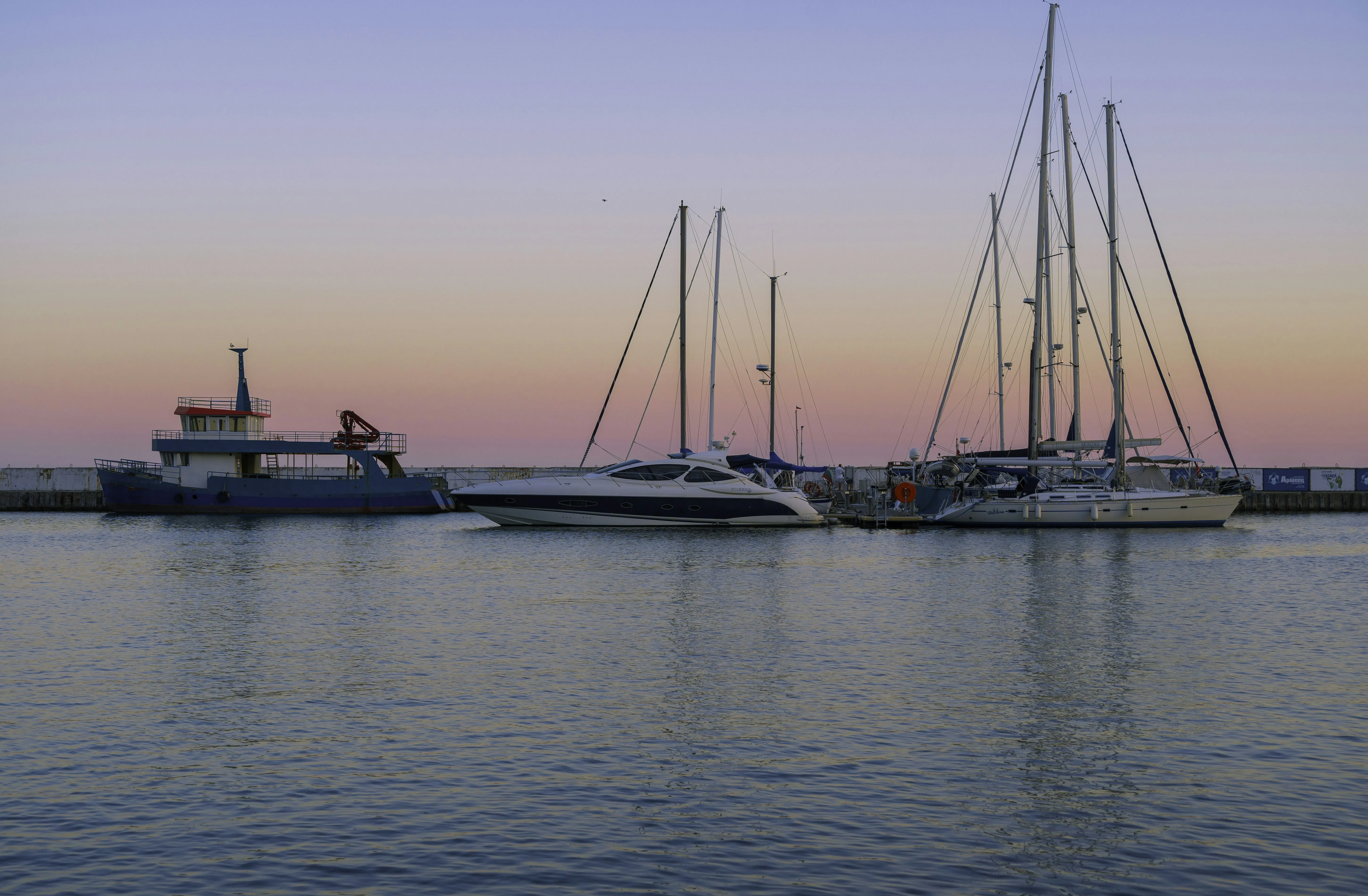 Boats Floating Quietly on Sea During Evening Light Wallpaper