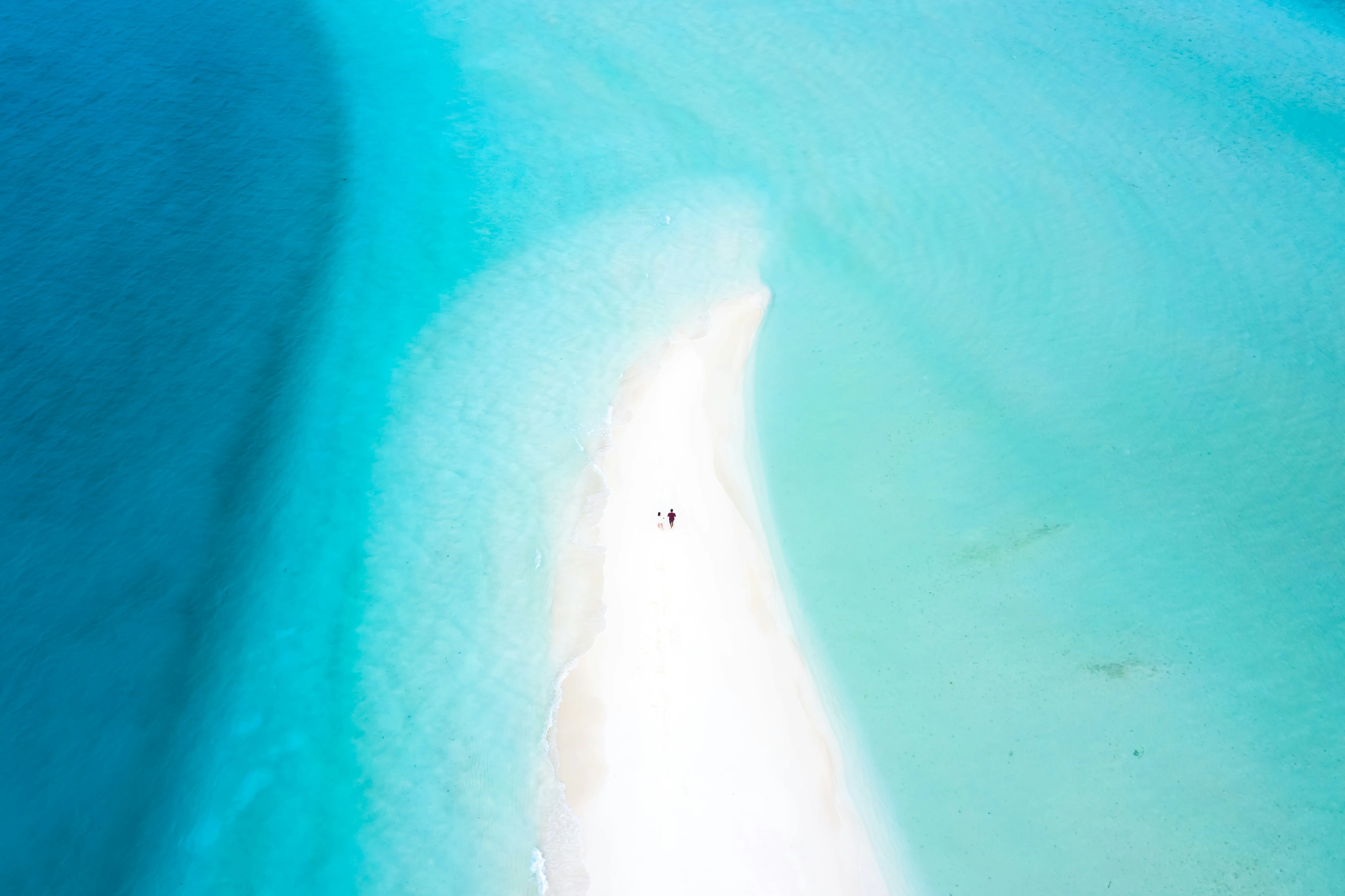 Bright Aerial View of White Beach and Blue Sea Wallpaper