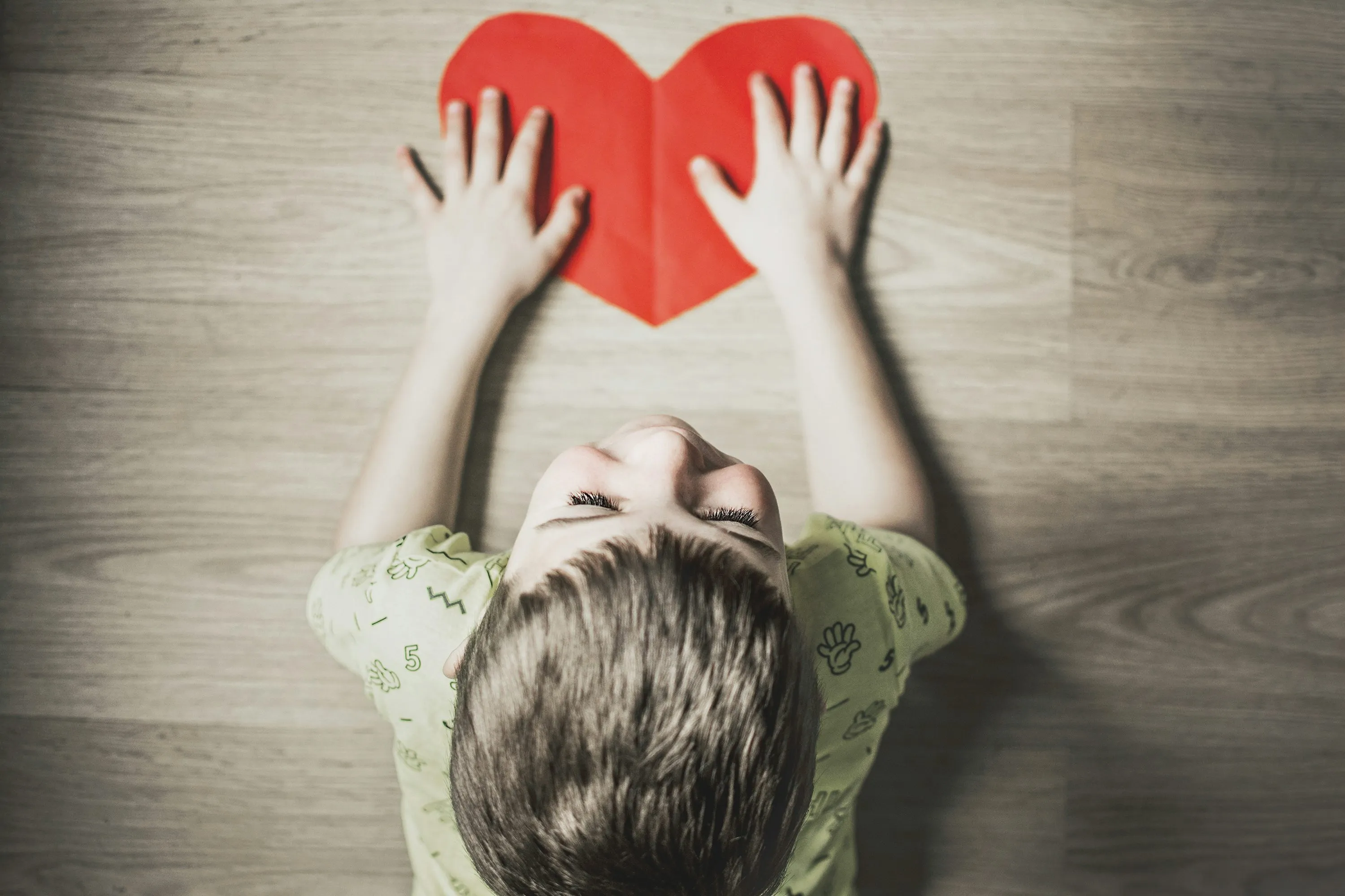 Child Holding Red Heart Showing Pure Emotion Wallpaper