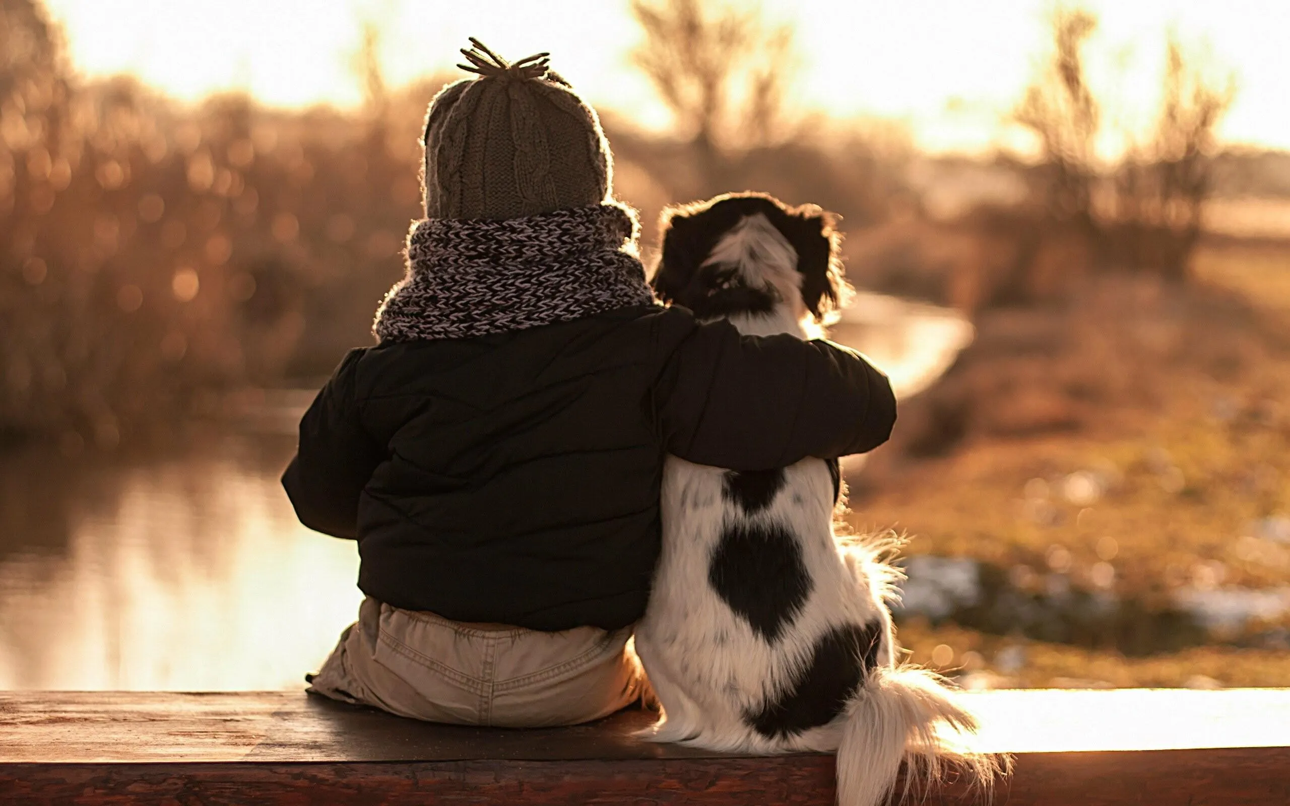 Child with Dog Sharing Warm Affection in Nature Wallpaper
