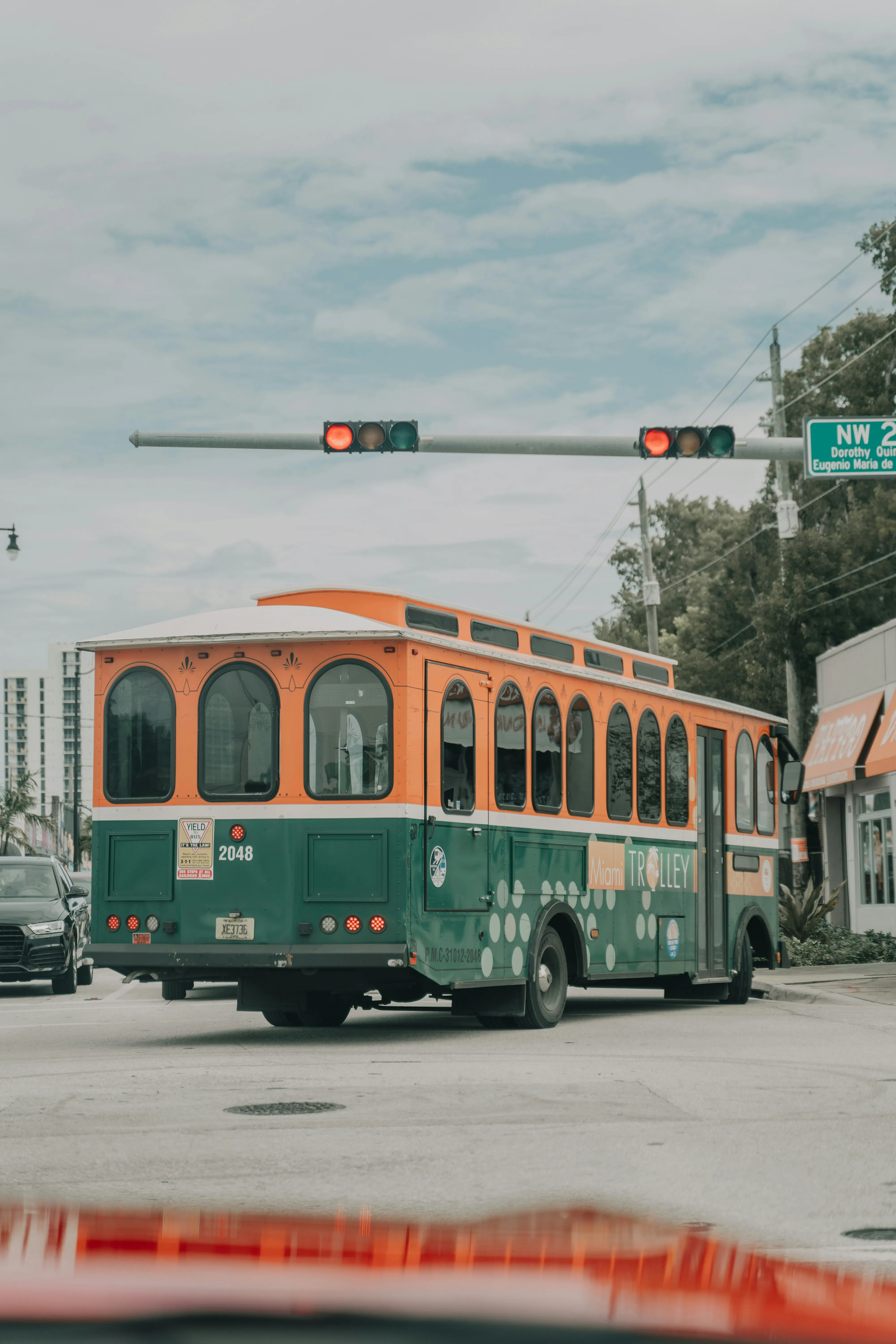 Classic Streetcar Moving Down Urban City Road Wallpaper