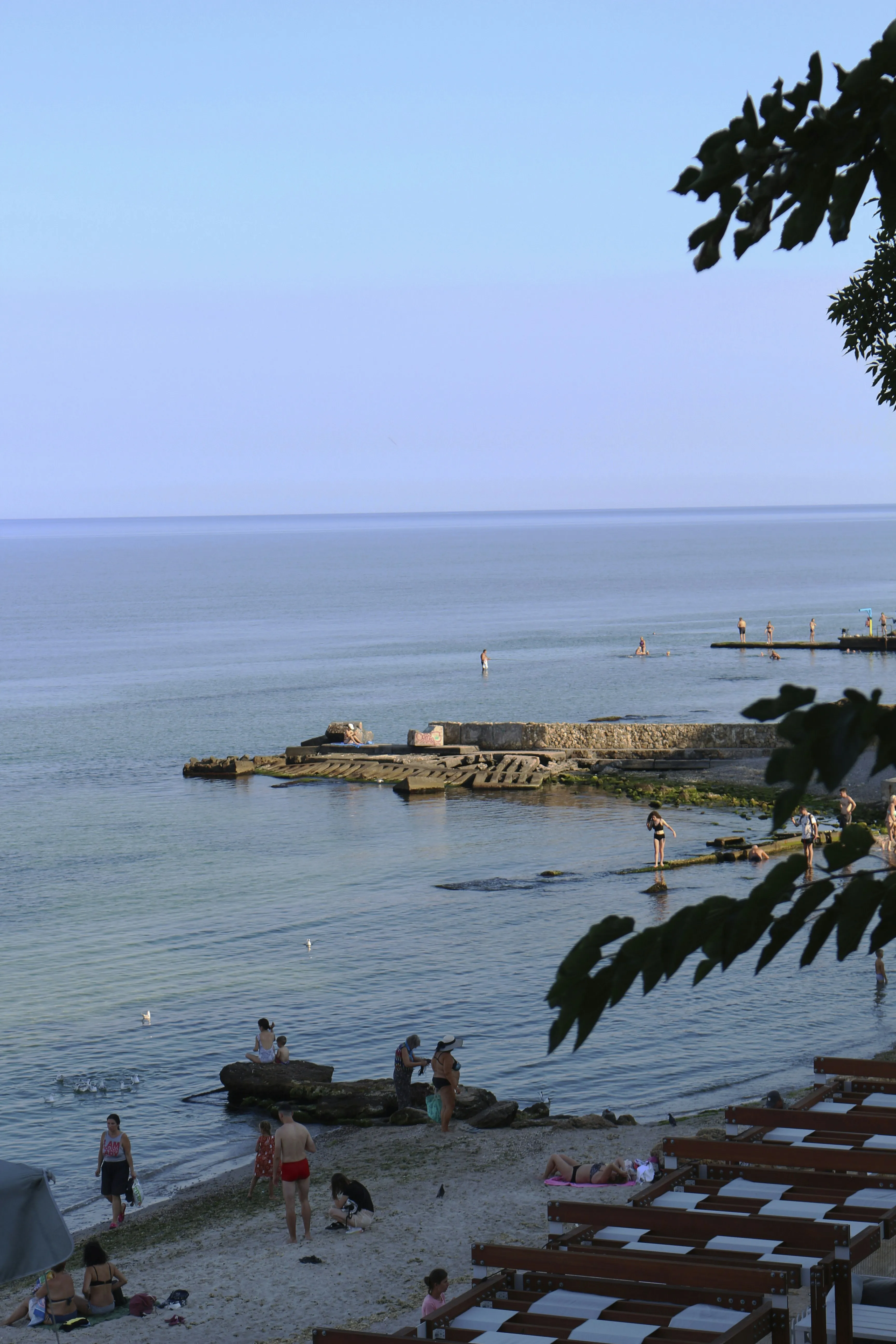 Coastal City View with Boats Floating in Sea Wallpaper
