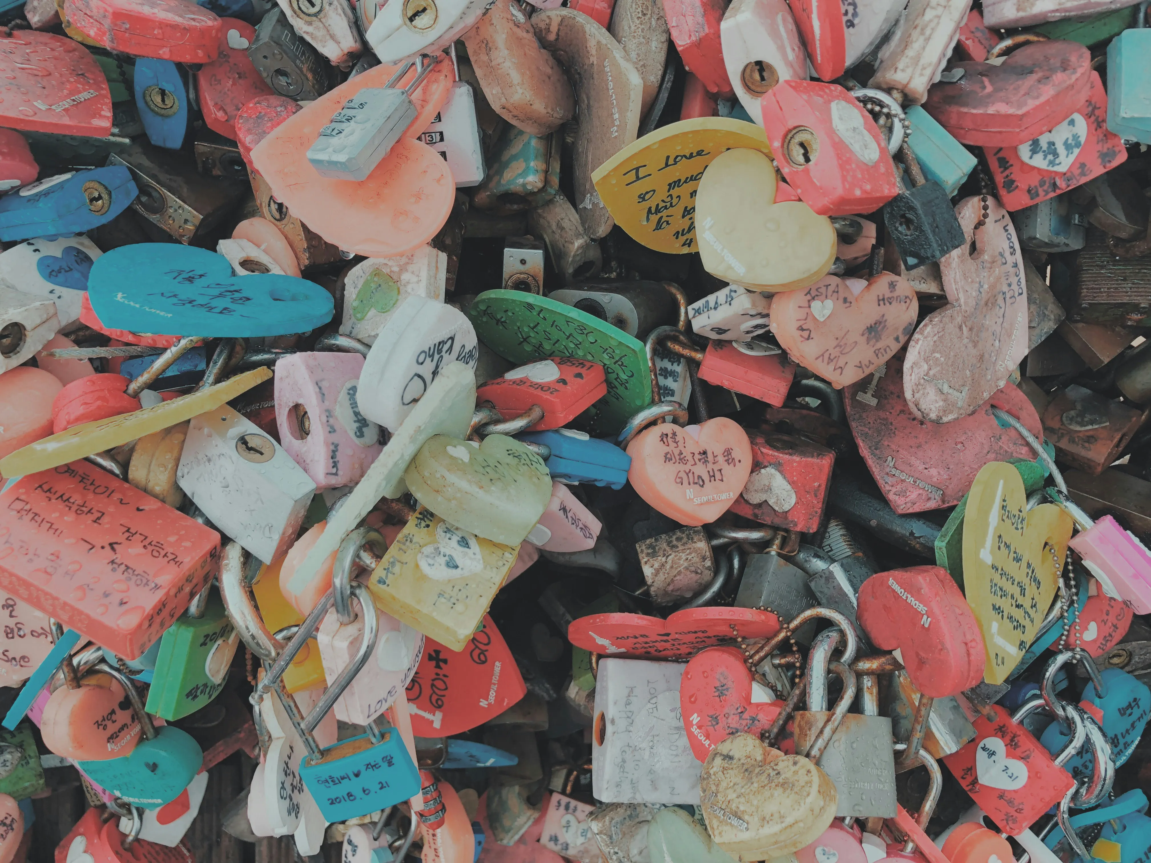 Colorful Locks Attached to Bridge as Love Symbols Wallpaper