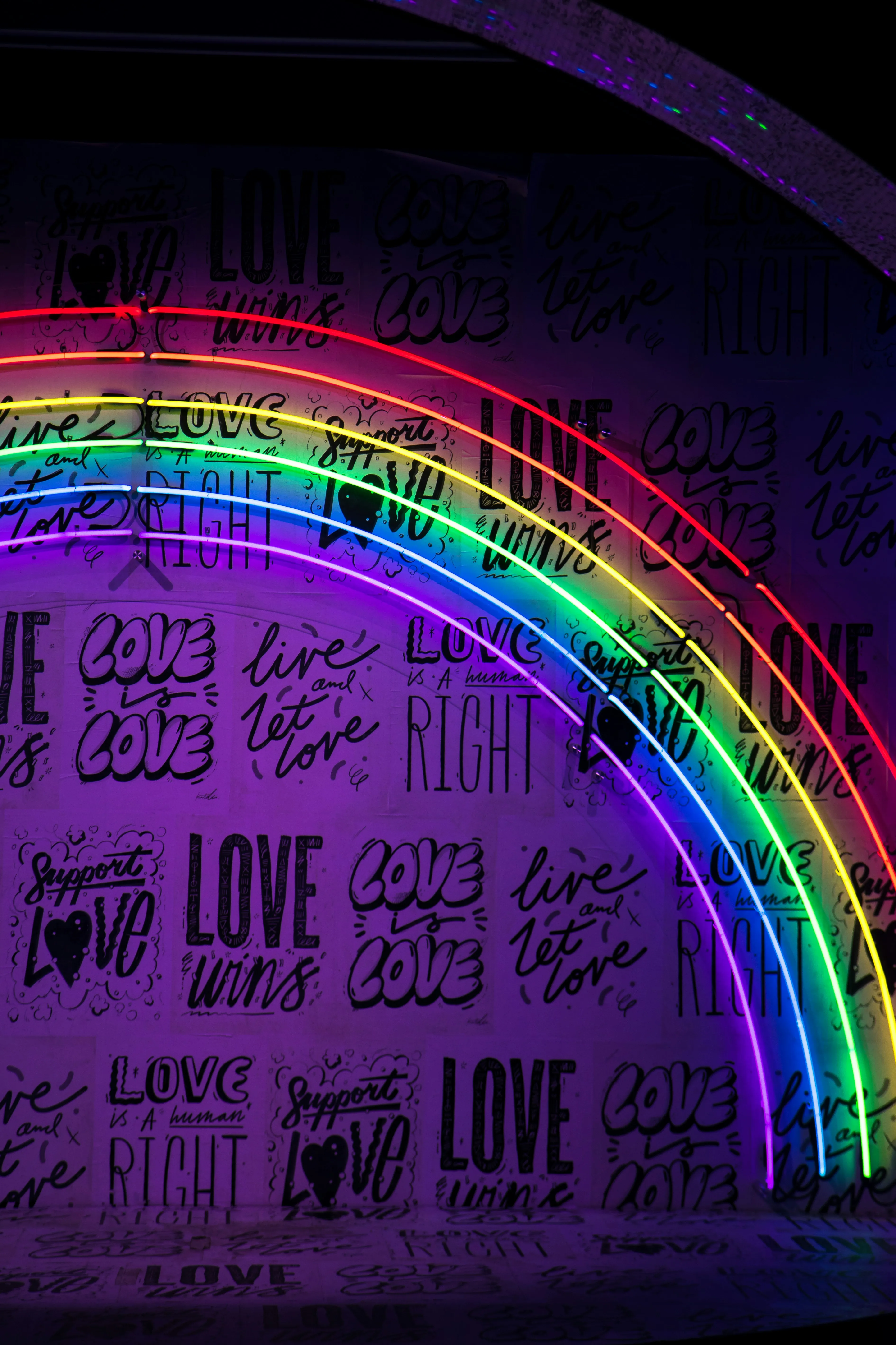 Colorful Rainbow Wall Spreading Joy and Pure Love Wallpaper