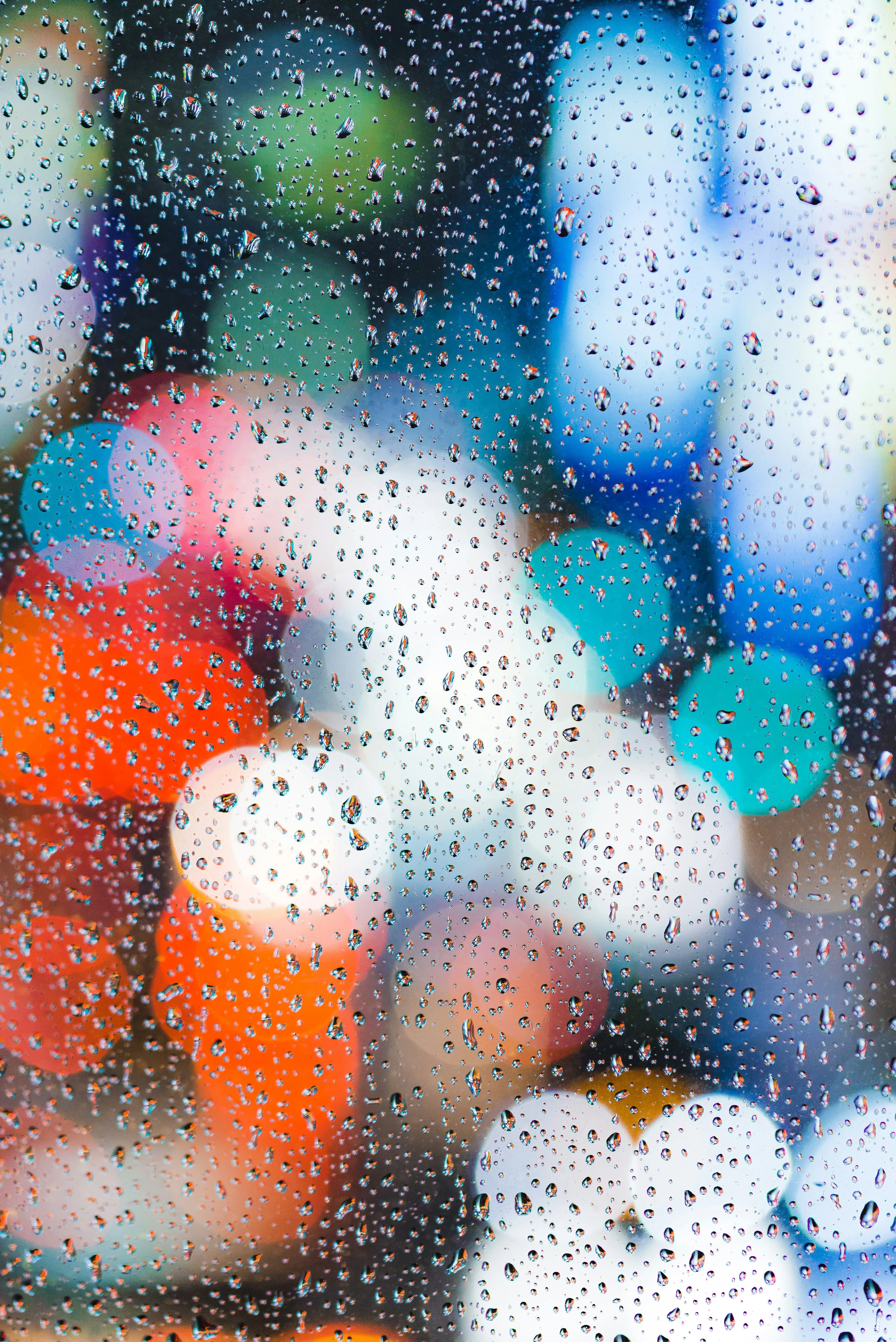 Colorful Raindrops on Glass Creating Dreamy Effect Wallpaper