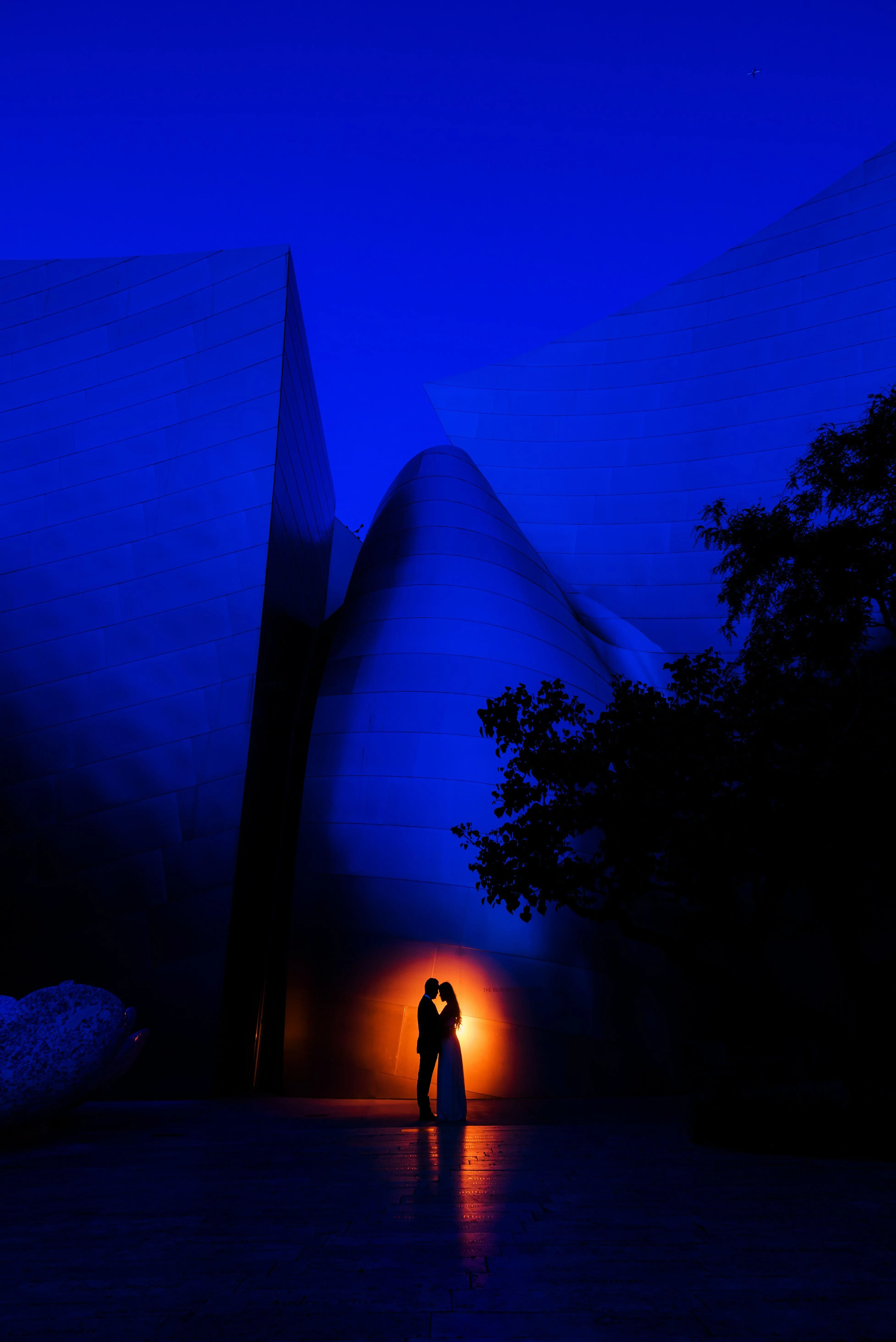 Couple at Night Surrounded by Deep Blue Glow Wallpaper