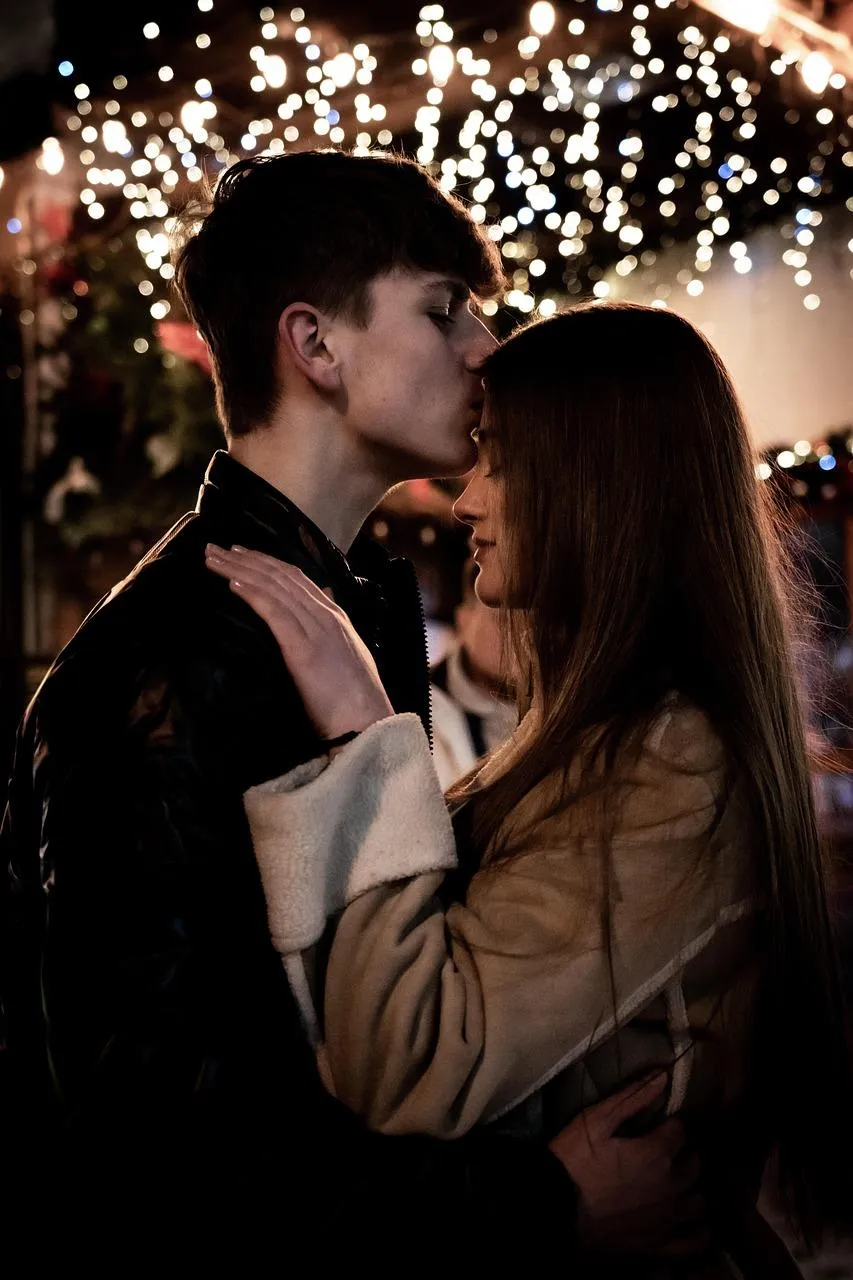 Couple Dancing in Snowlit Romantic Celebration Wallpaper