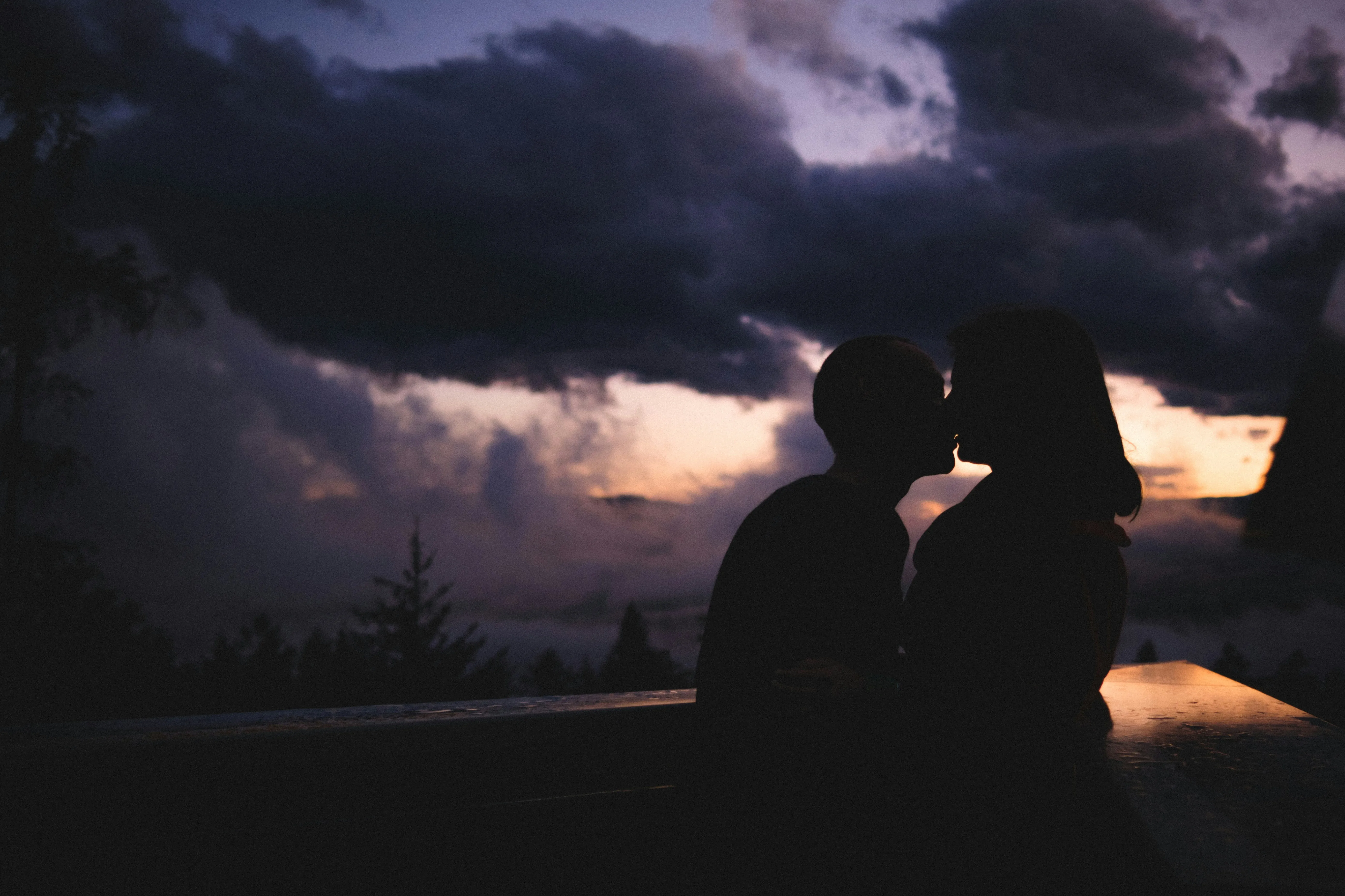 Couple Hugging at Sunset Showing Deep Connection Wallpaper