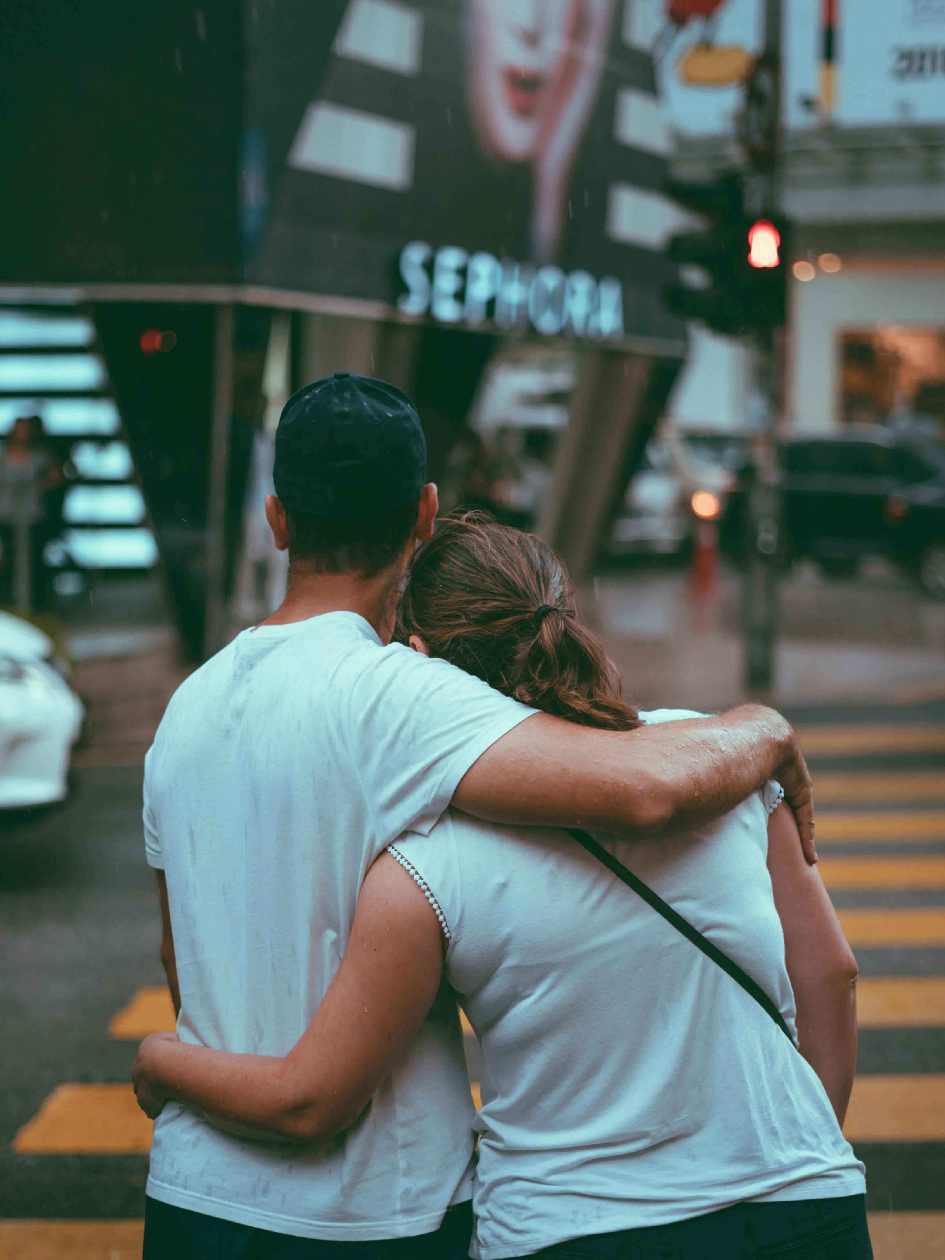 Couple Hugging Happily in Busy City Street Wallpaper