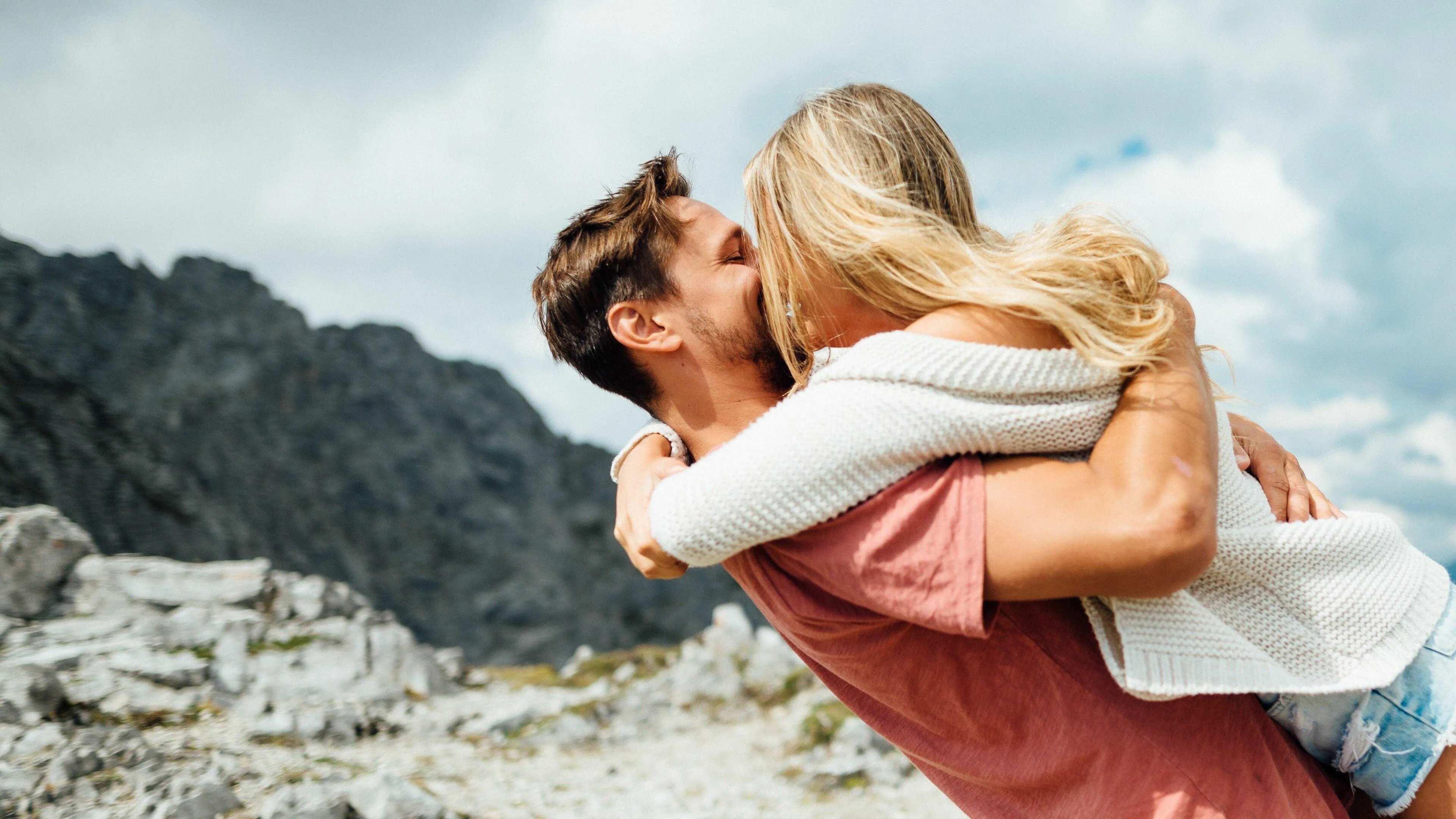 Couple Hugging Outdoors in Warm Golden Light Wallpaper