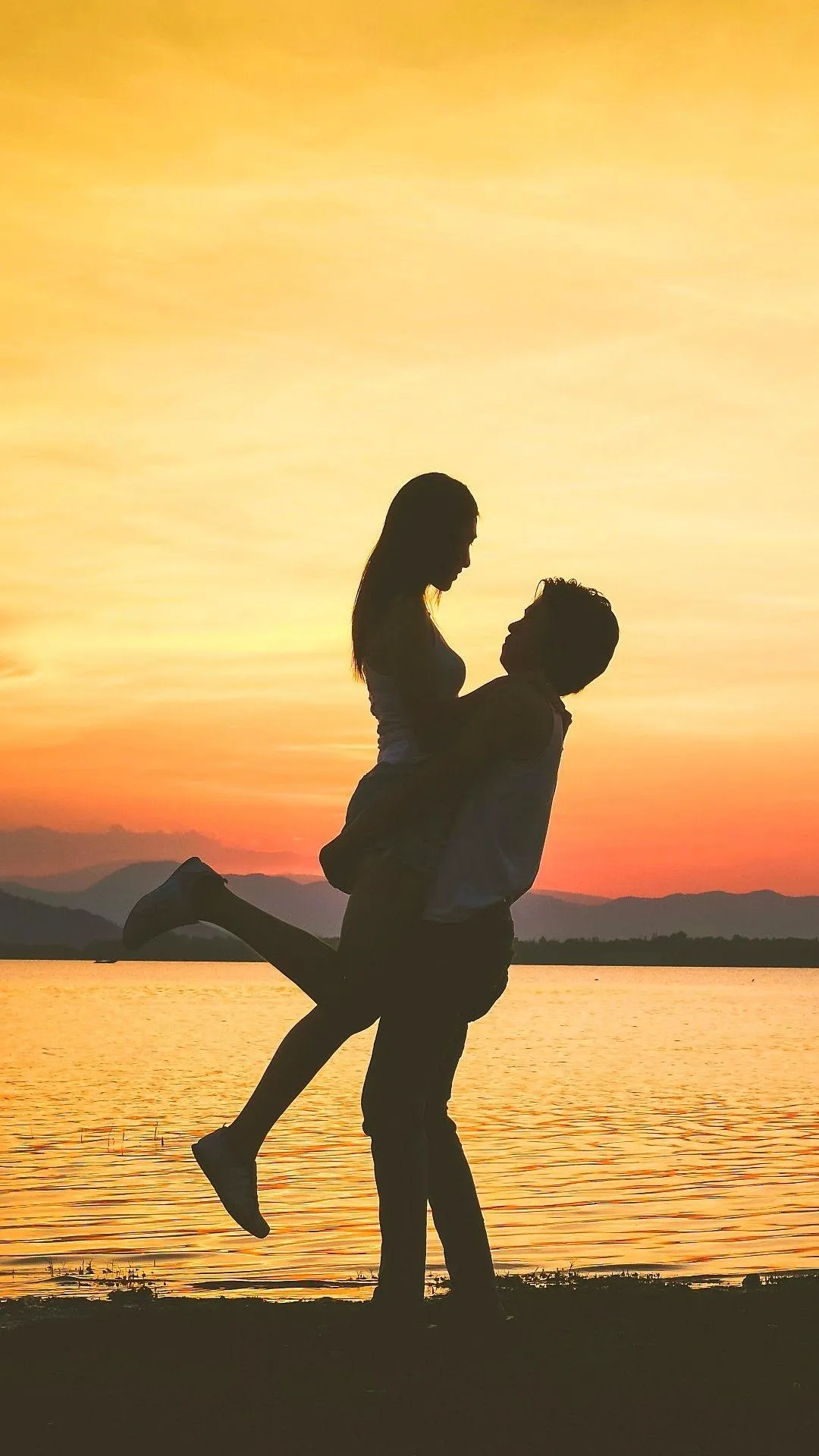 Couple Lifting Pose at Sunset Showing True Happiness