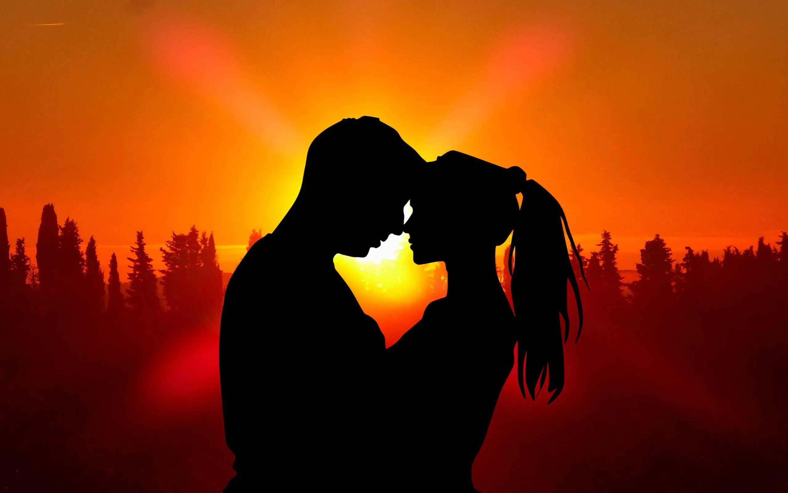 Couple Making Heart Shape with Sunset Glow Wallpaper