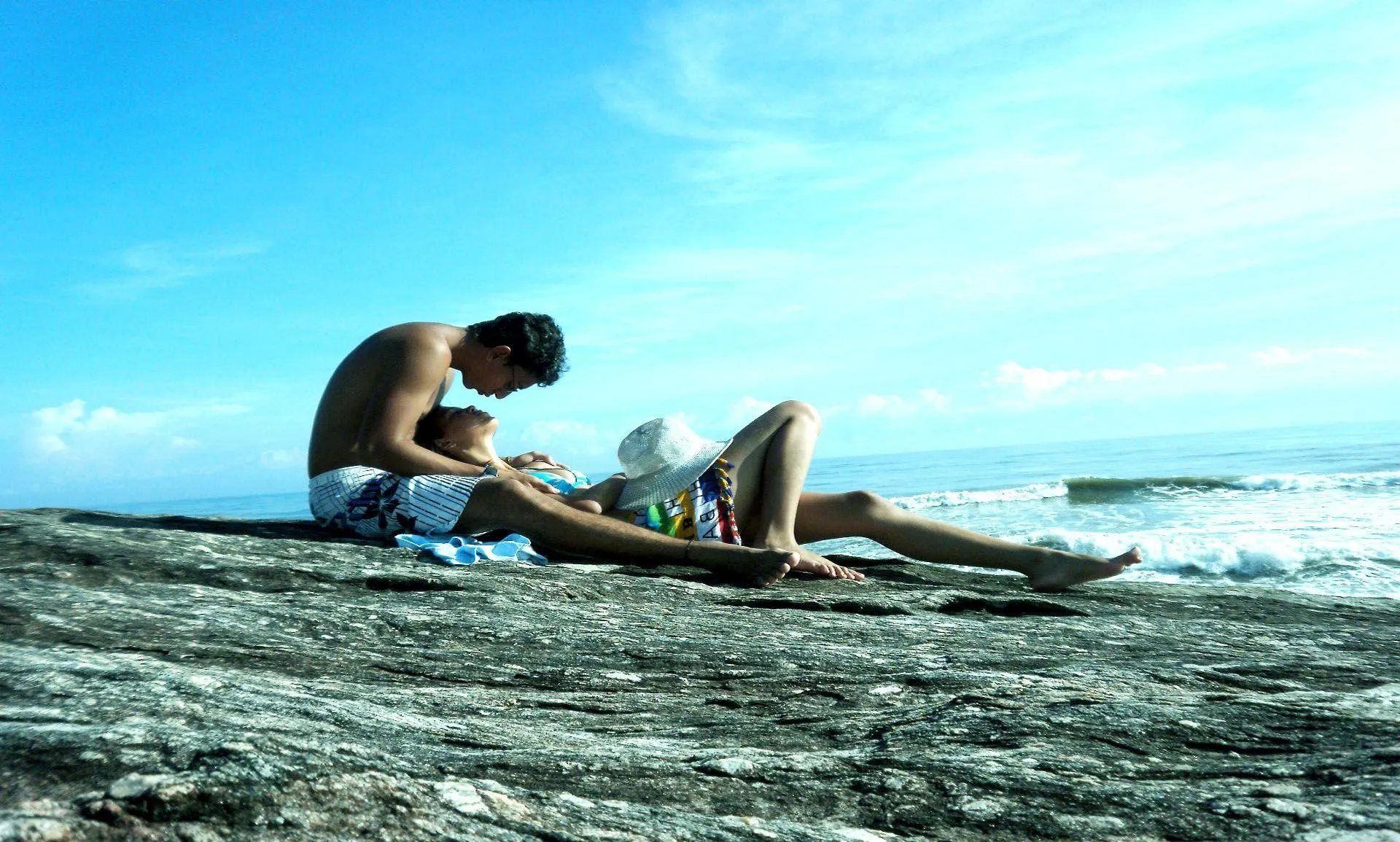Couple on Beach Sharing Calm and Blissful Love Wallpaper