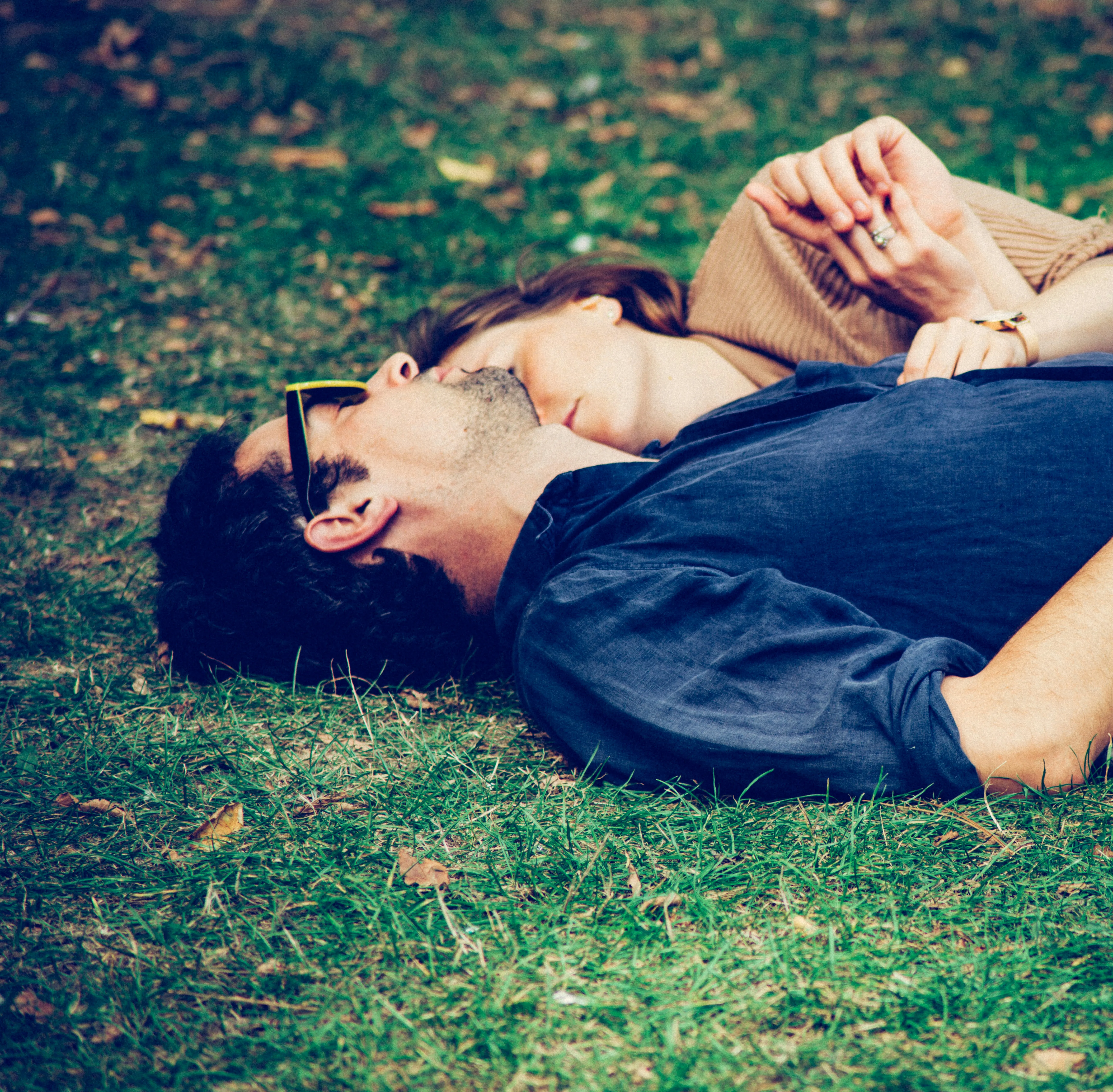 Couple Resting Together on Grass in Peaceful Park Wallpaper