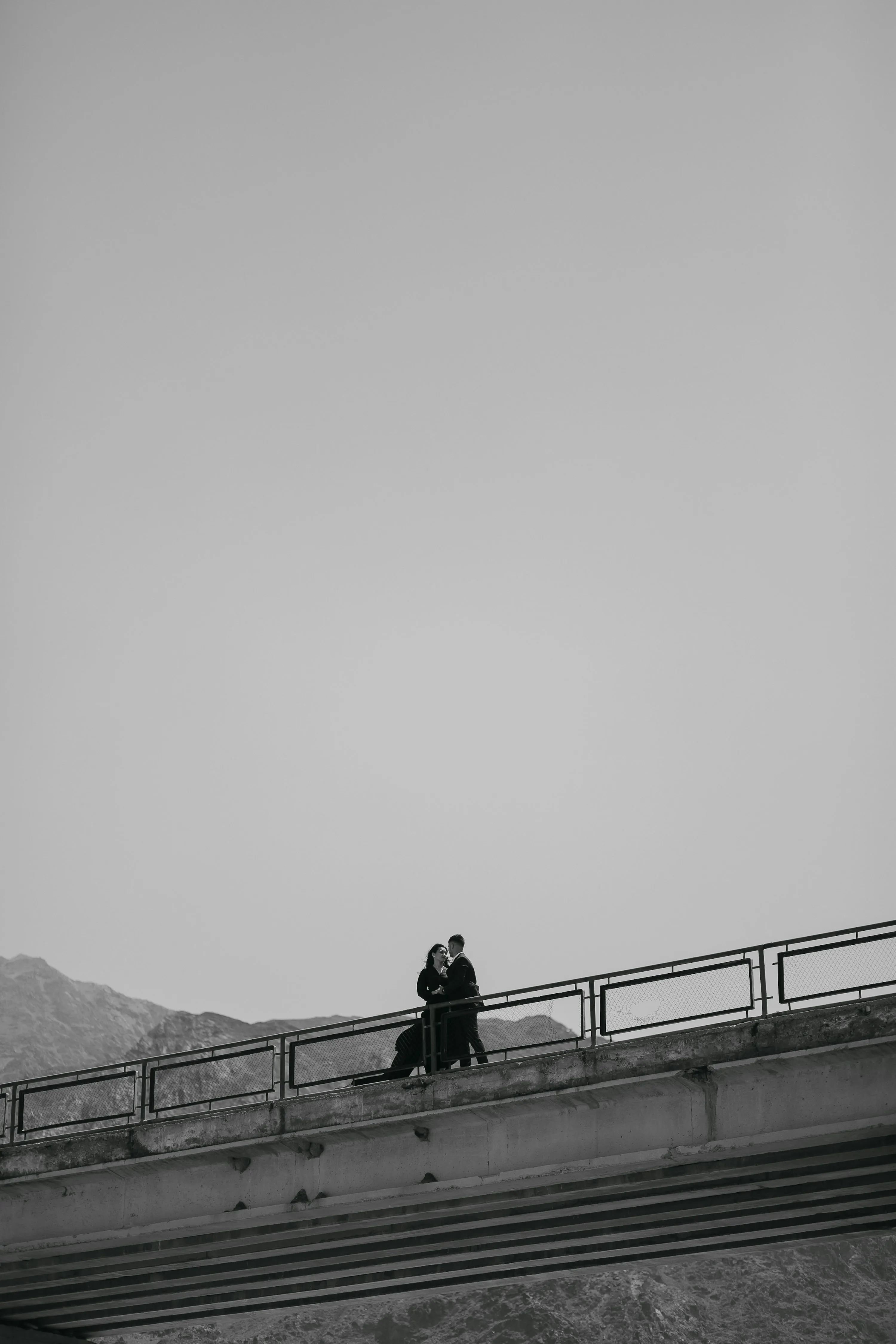 Couple Sharing a Quiet Romantic Moment on a Bridge
