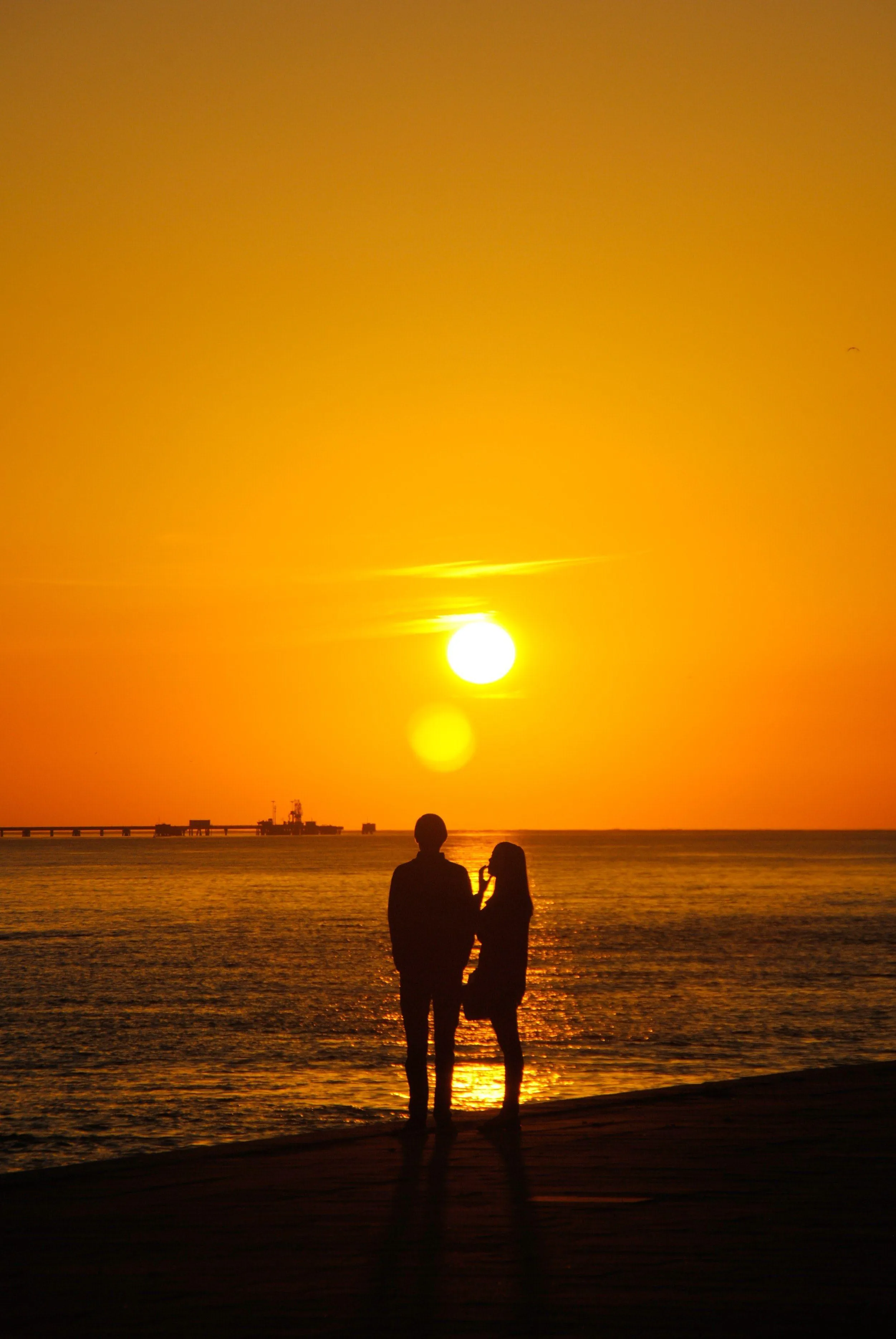 Couple Walking at Sunset Holding Hands Closely Wallpaper