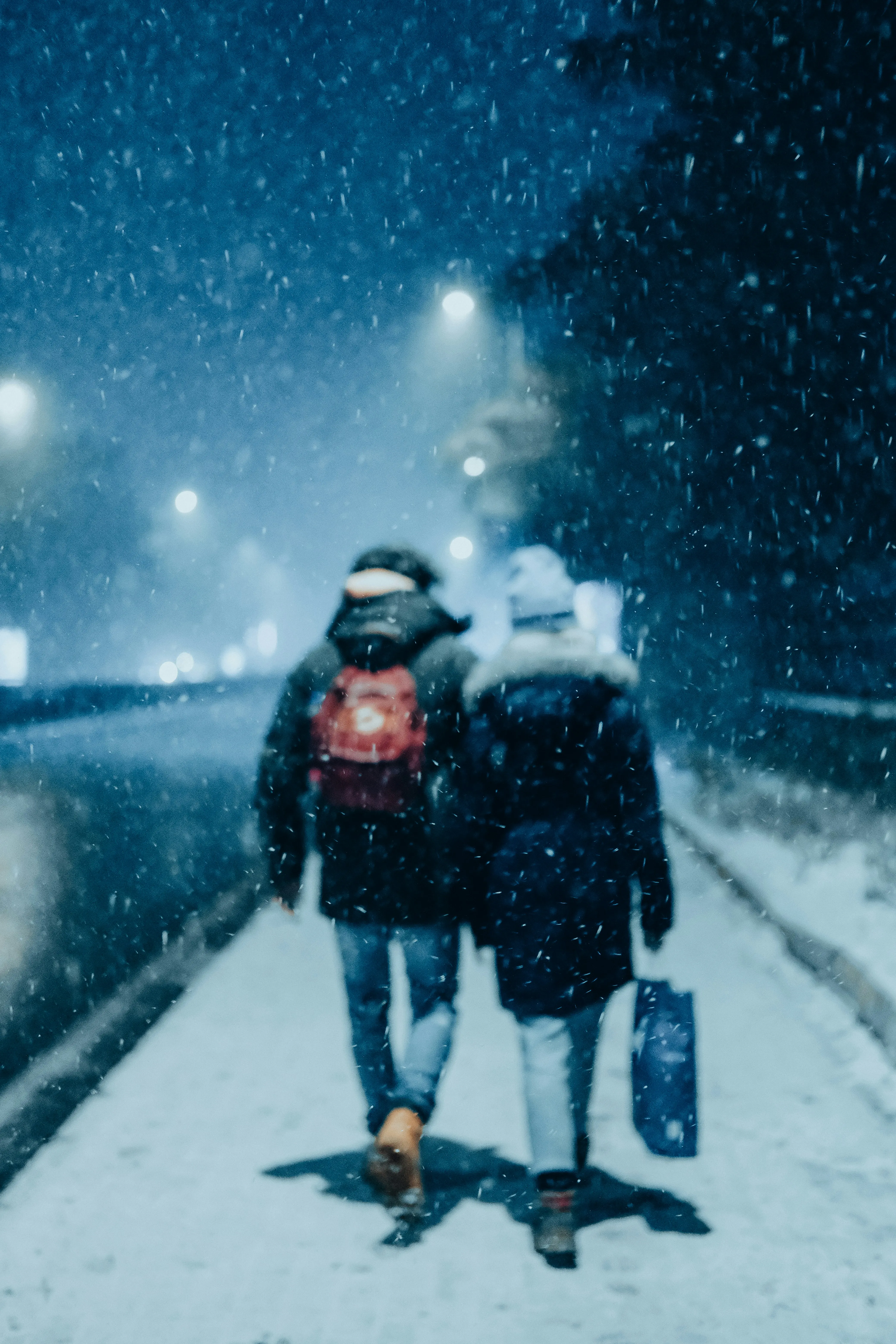 Couple Walking in Snow Expressing Winter Romance Wallpaper