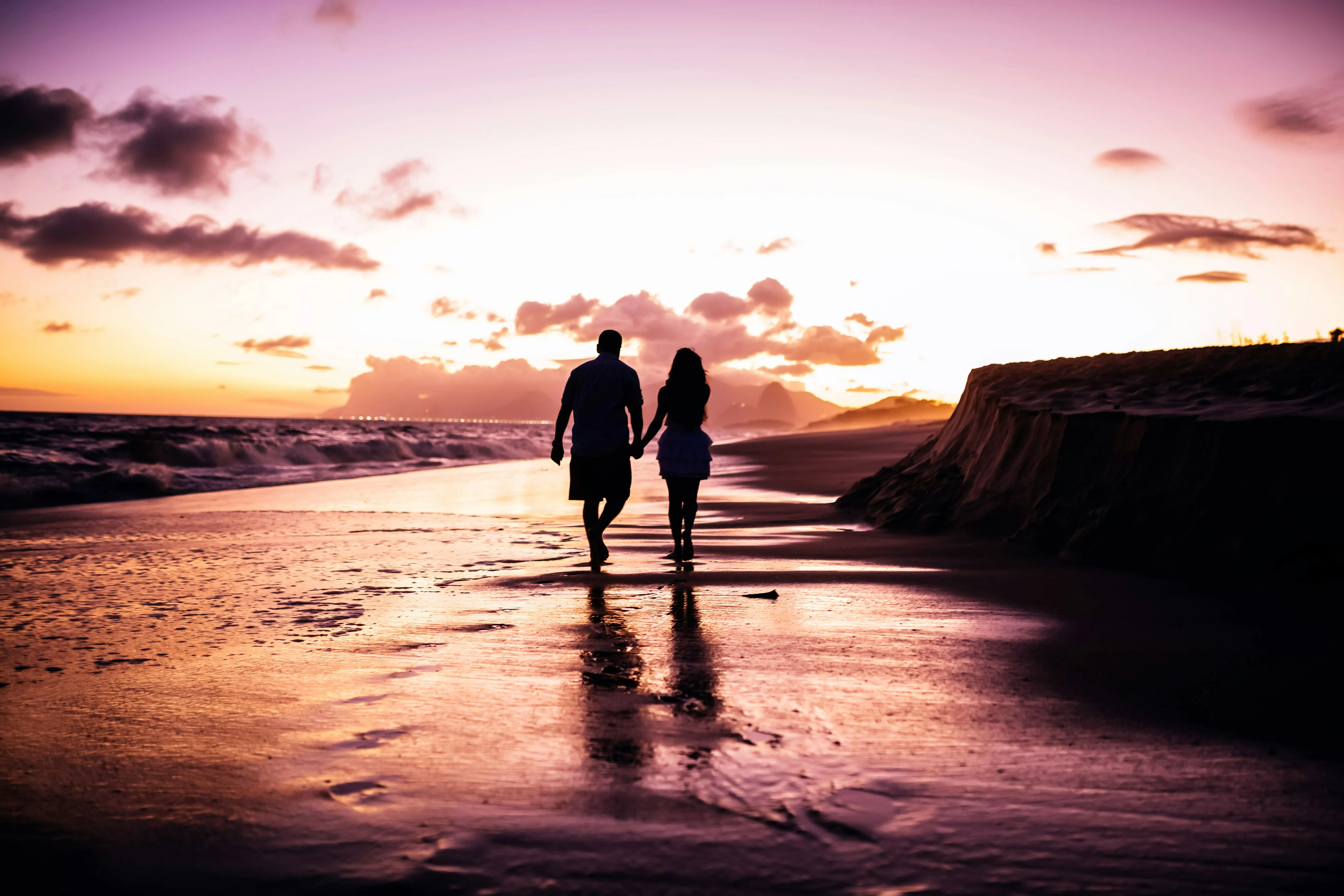 Couple Walking Together Along the Beach Sunset Wallpaper