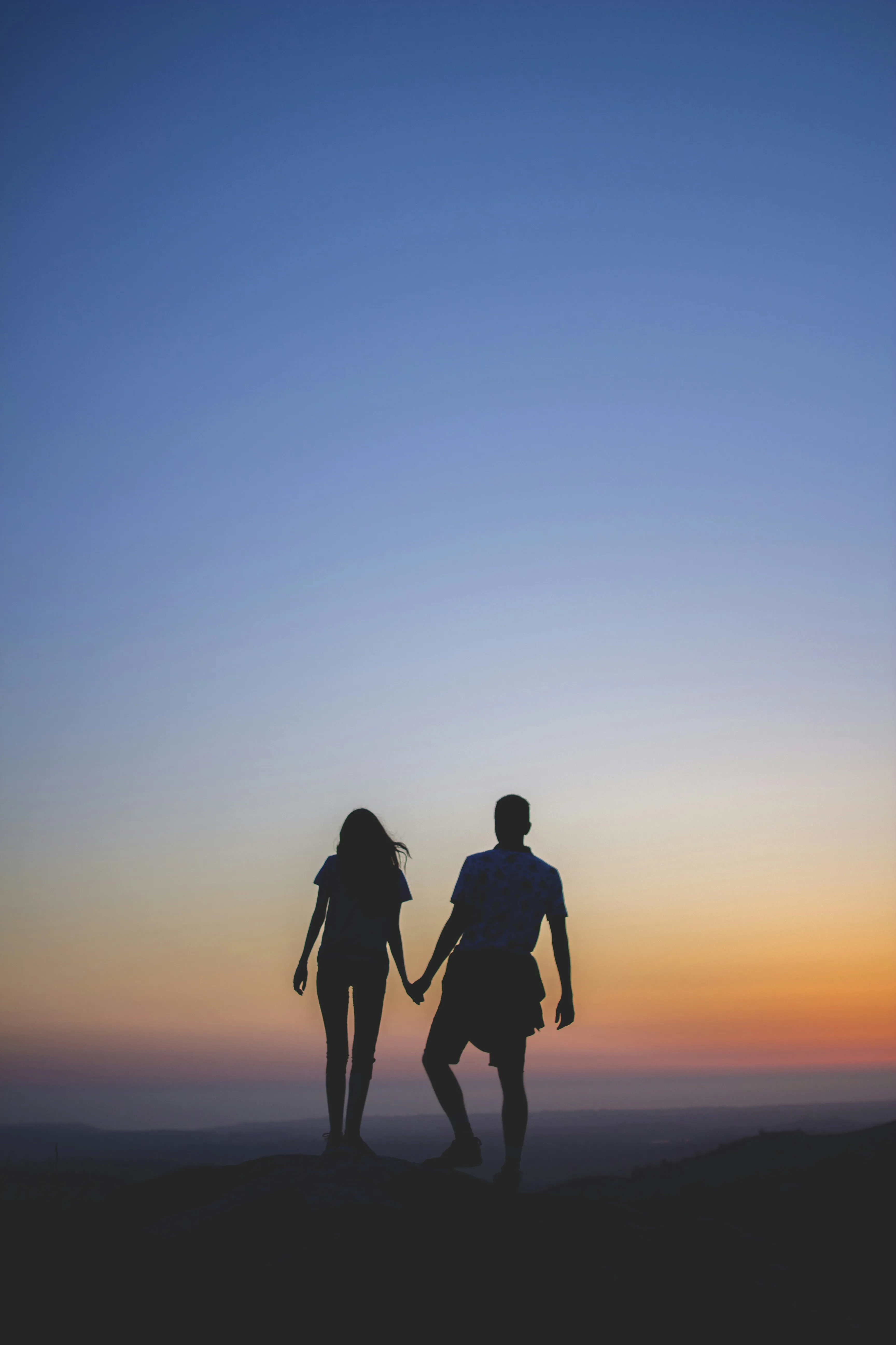 Couple Walking Together Toward the Evening Light Wallpaper