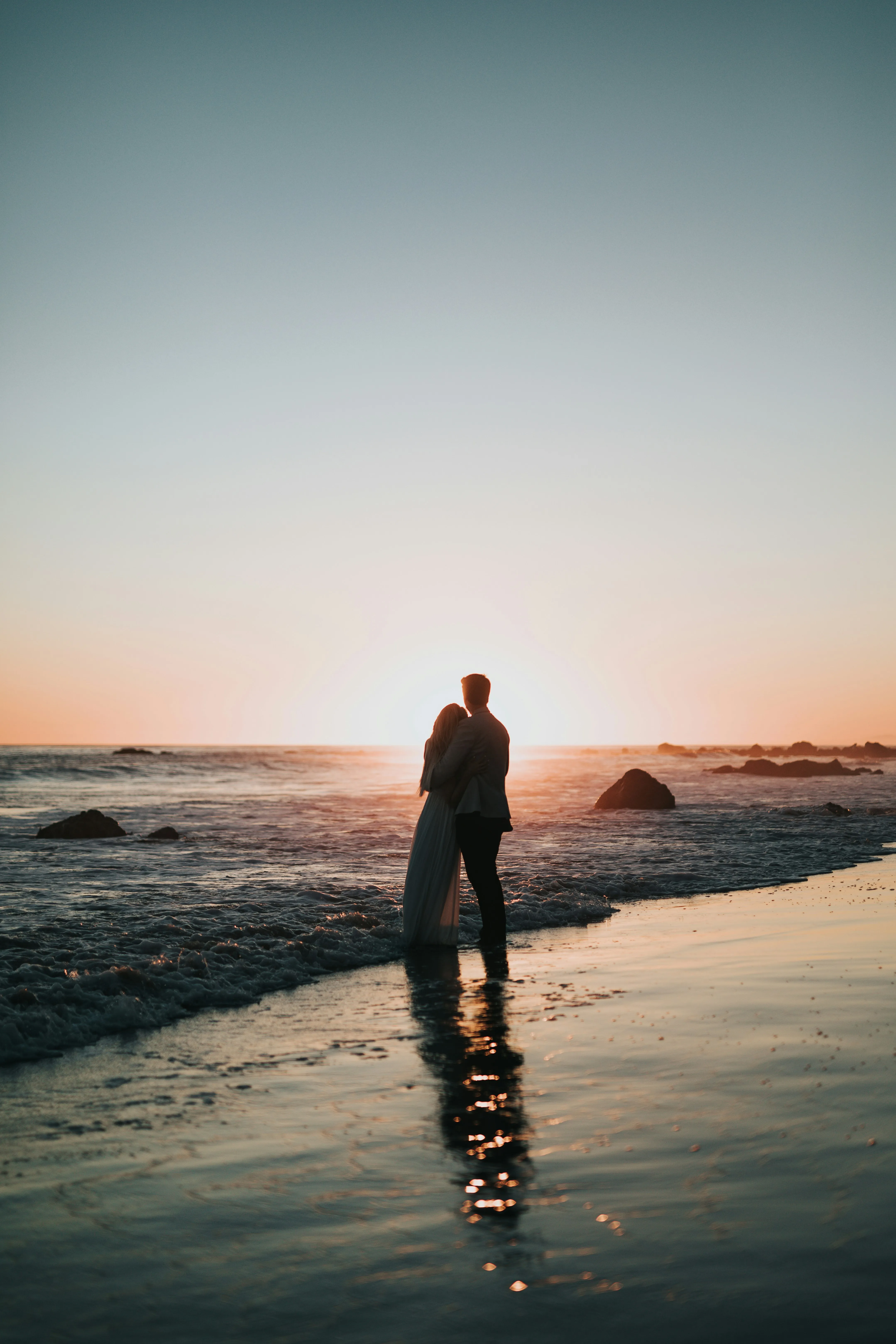 Couples Standing on Beach Reflecting Inner Feelings Image