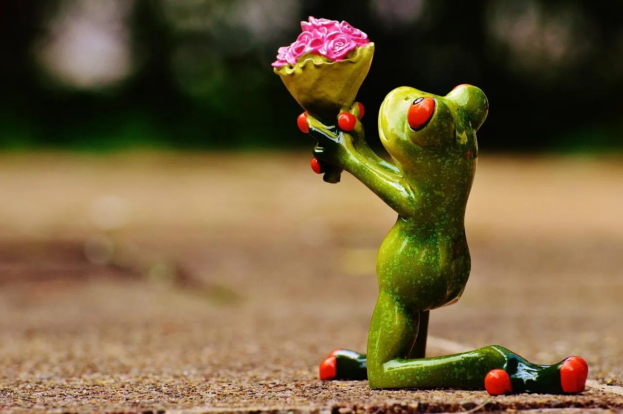 Cute Frog Offering Flowers as a Gesture of Love Wallpaper