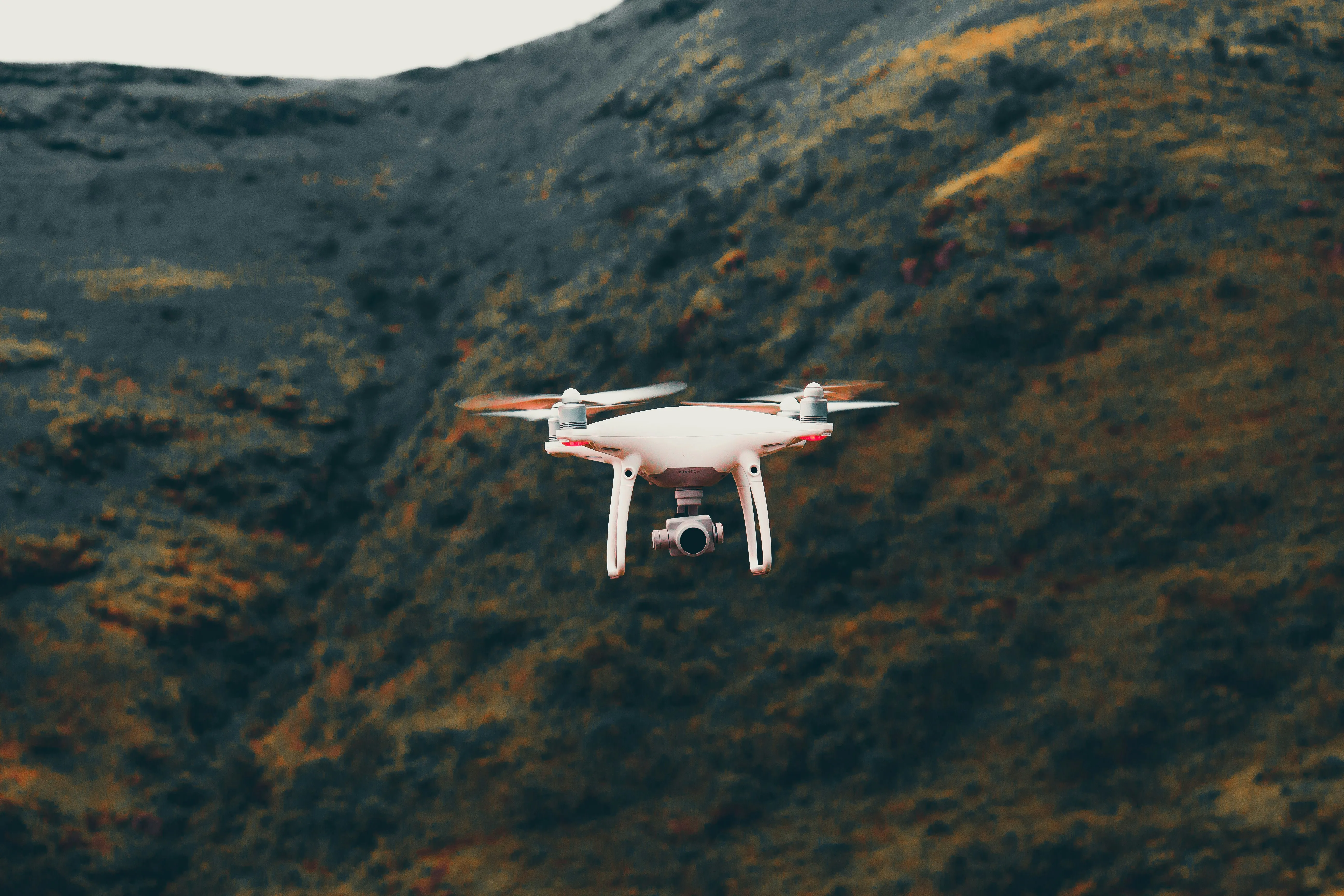 Drone Flying Over Hills Capturing Serene Beauty Wallpaper