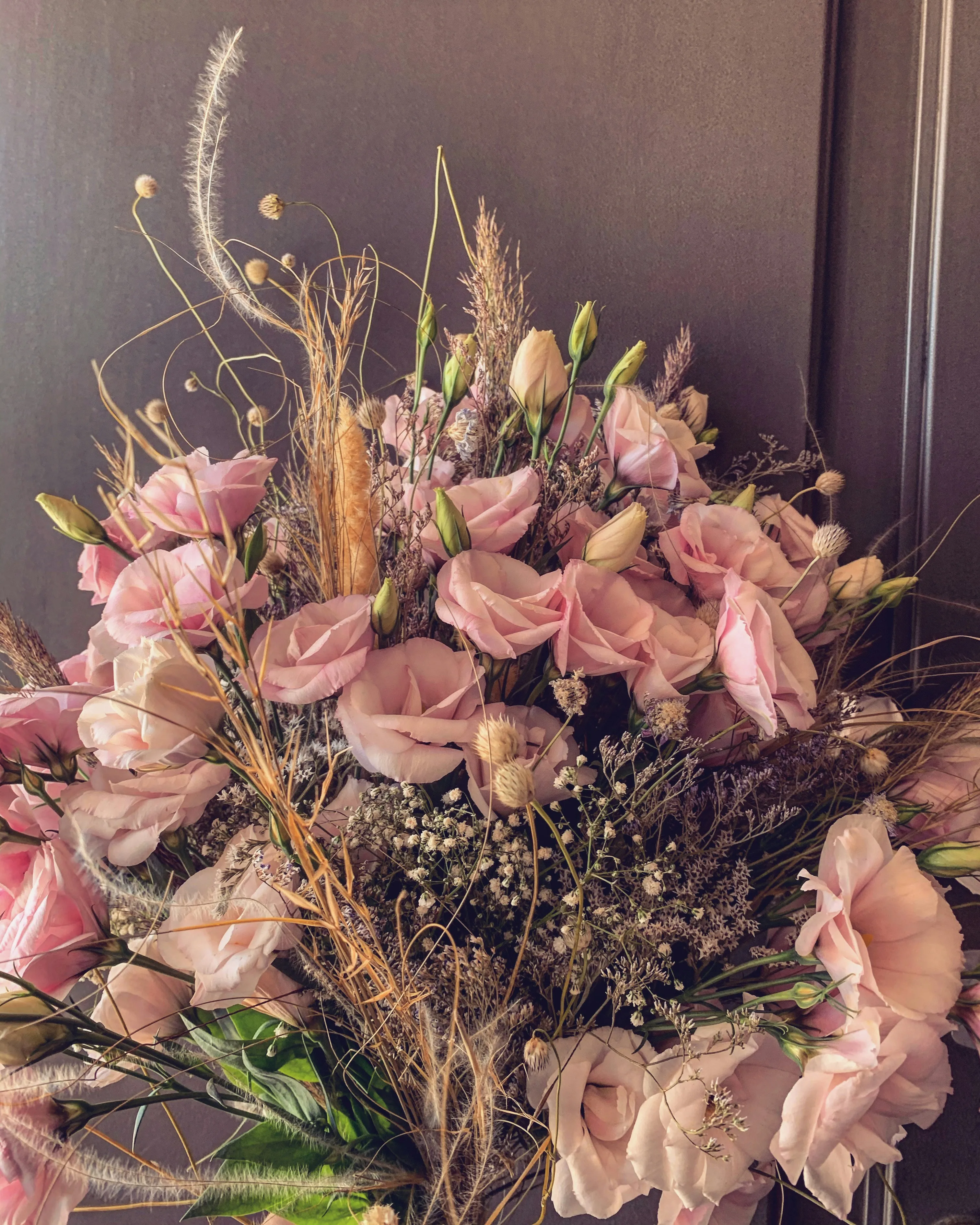 Elegant Bouquet of Flowers Arranged in Soft Light Wallpaper