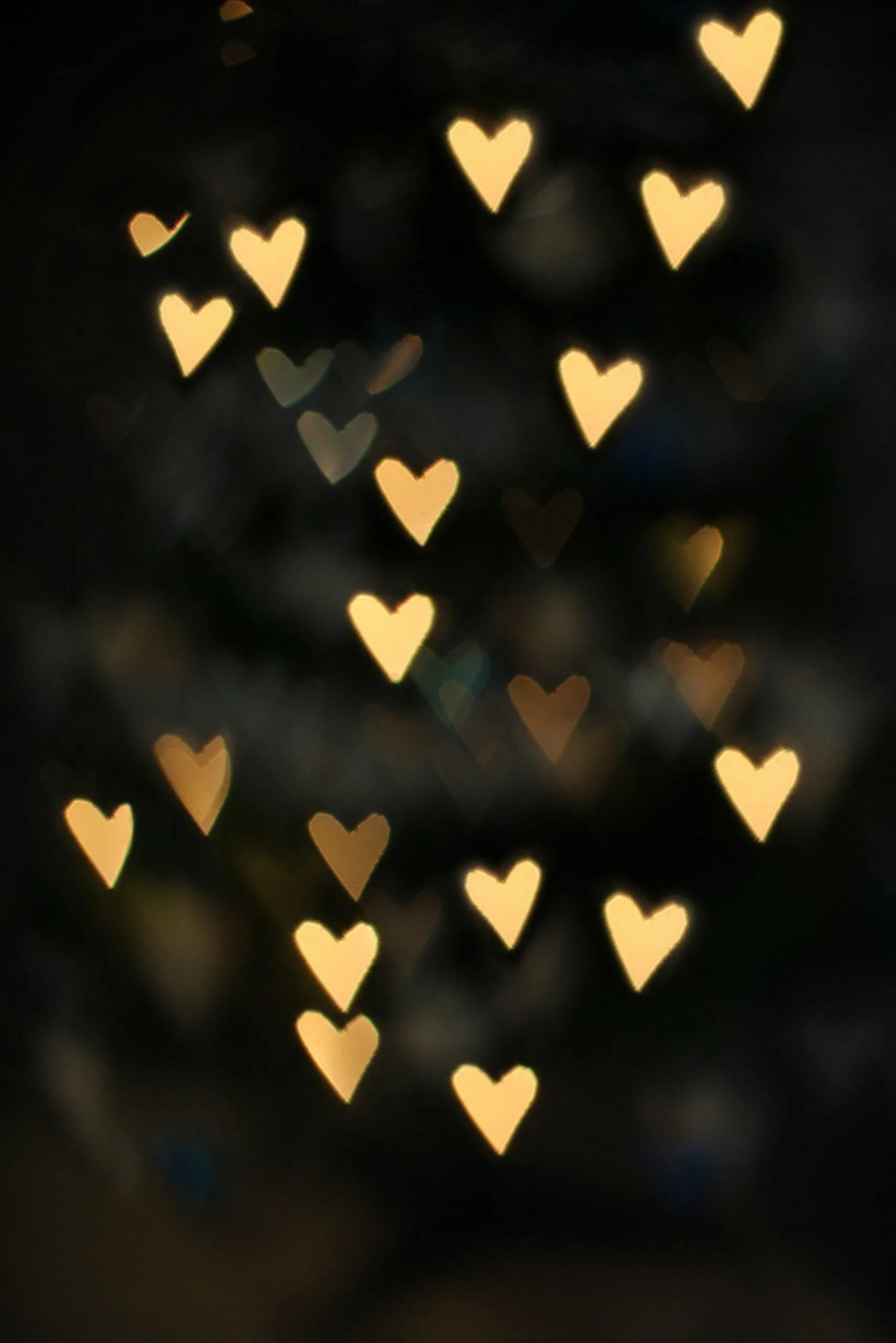 Floating Golden Hearts on Elegant Black Background Wallpaper
