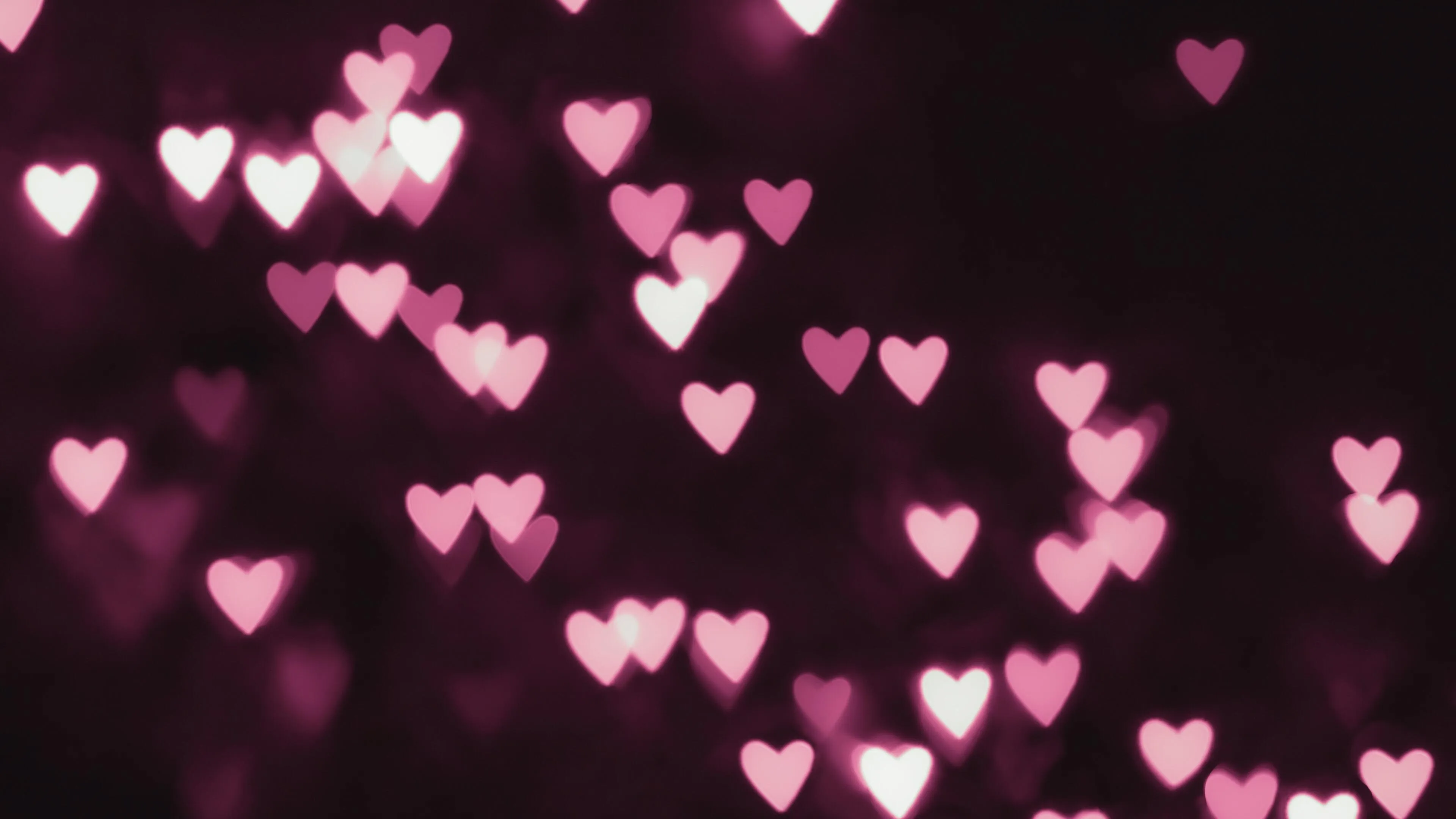 Flowing Pink Hearts Representing Joyful Romance Wallpaper