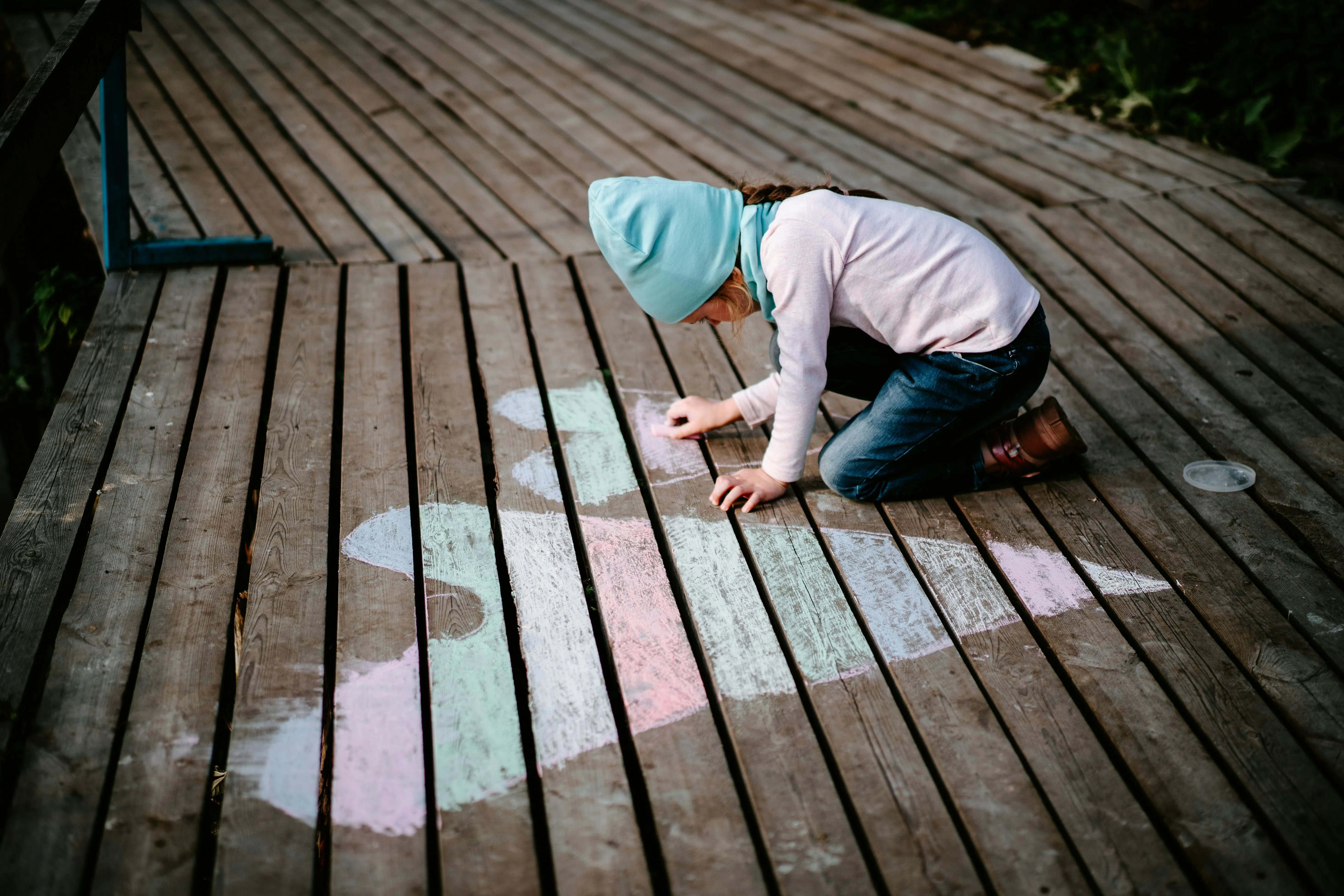 Girl Drawing Heart Shape on Wooden Ground Path Wallpaper