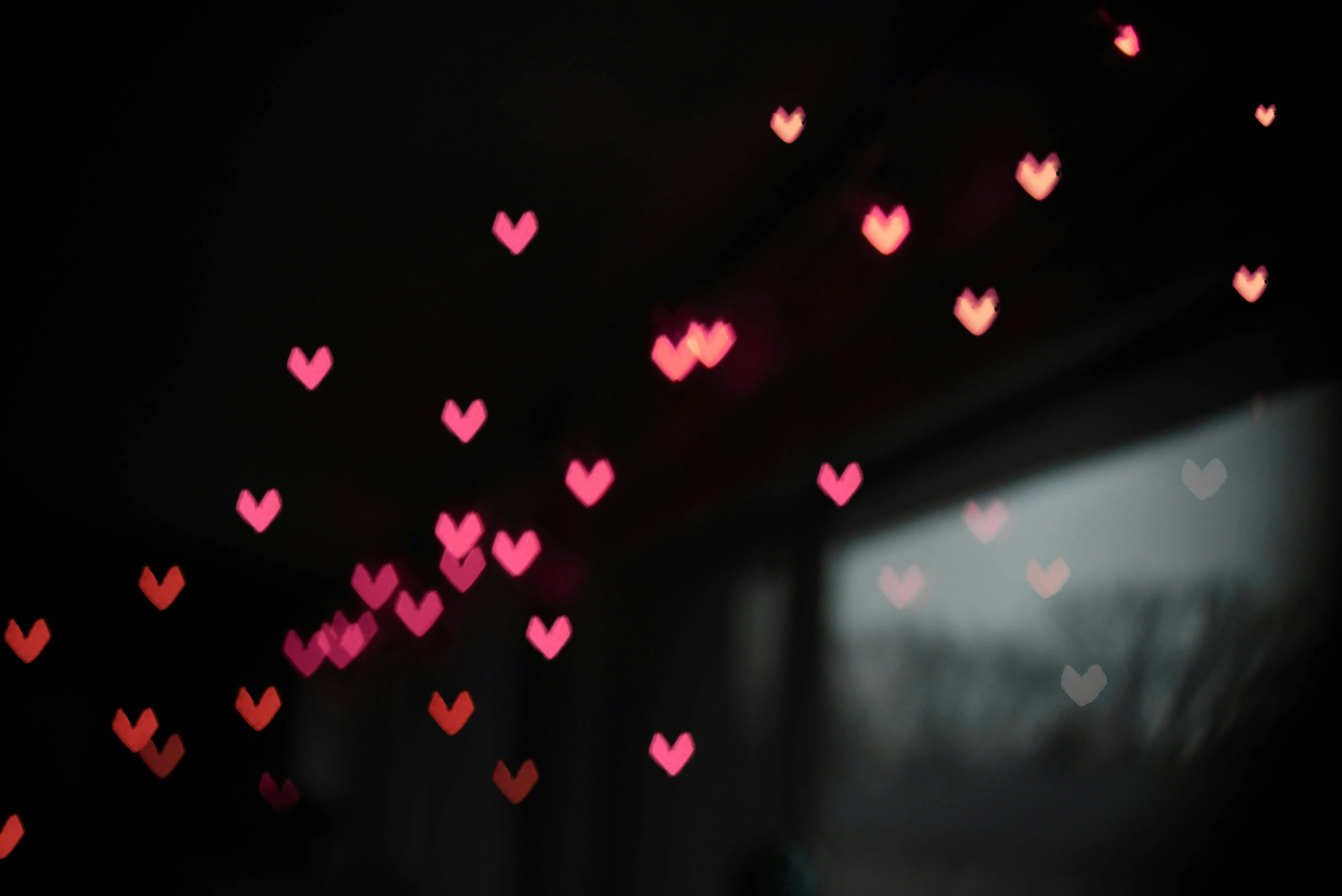 Glowing Hearts in Dark Expressing Romance Wallpaper