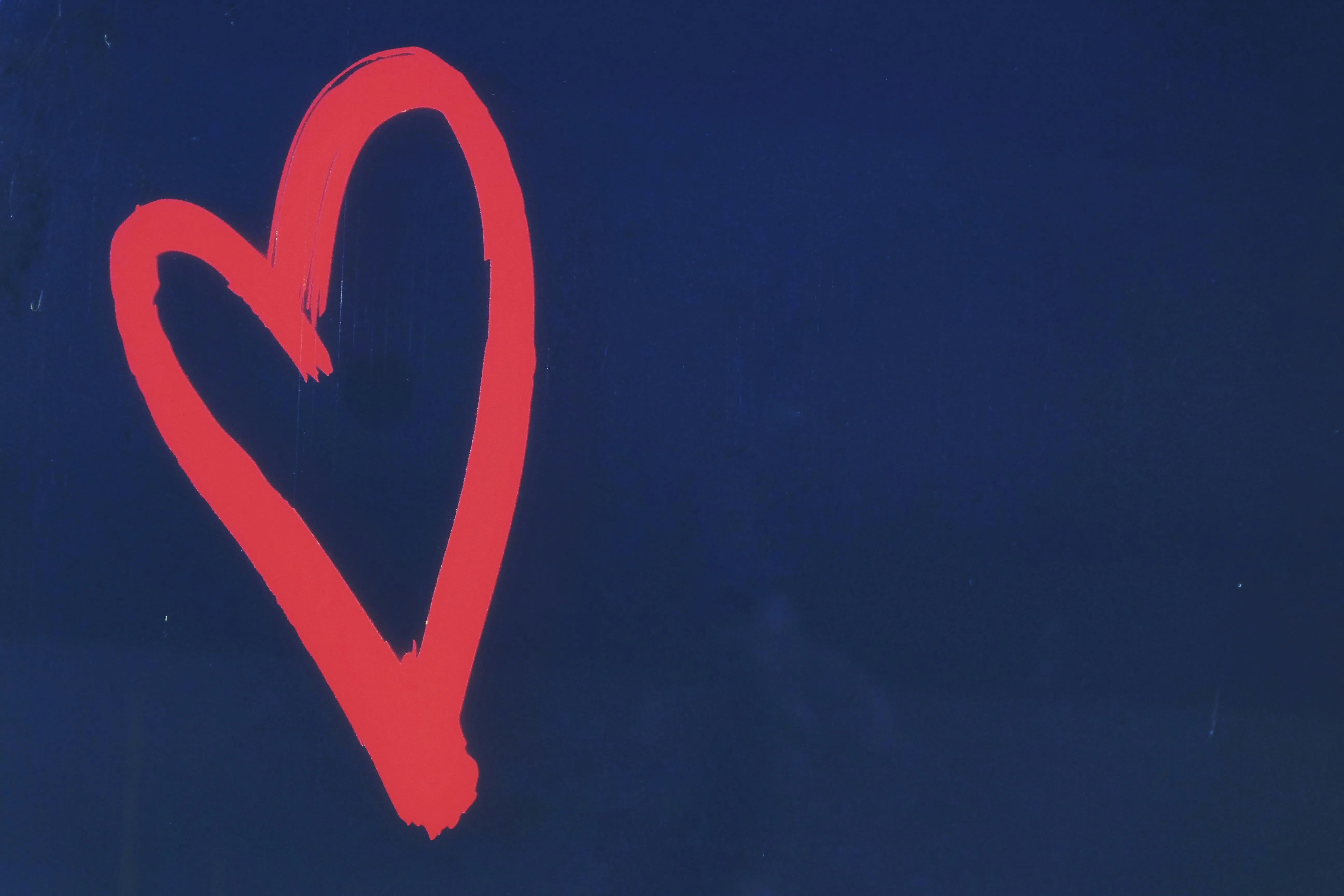 Glowing Red Heart on Dark Sky of Endless Devotion Wallpaper