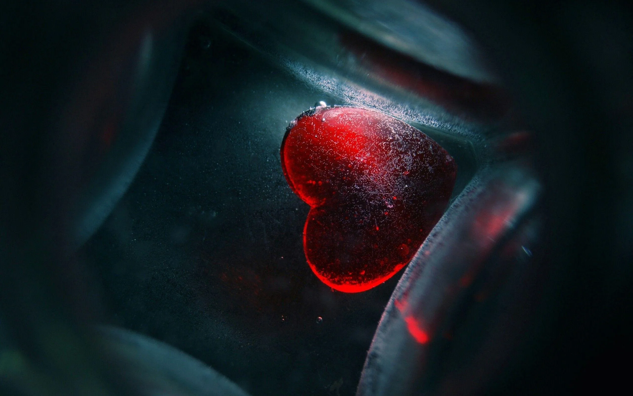 Glowing Red Heart Surrounded by Deep Blue Light Wallpaper