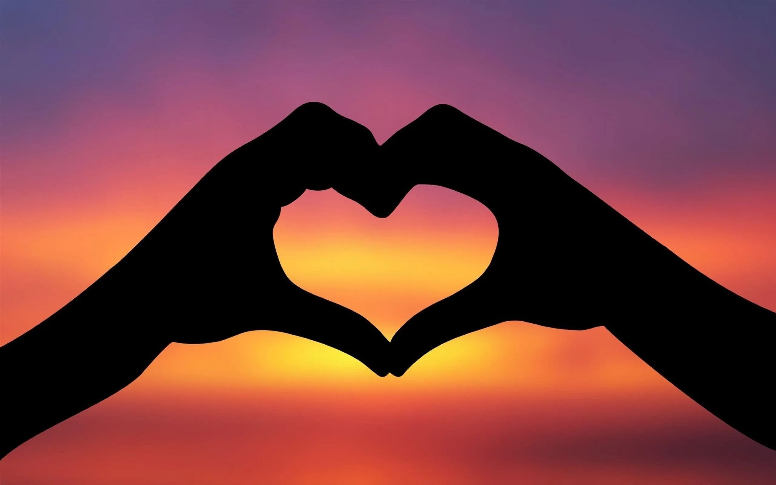 Hands Forming Heart in Beautiful Sunset Symbol of Love