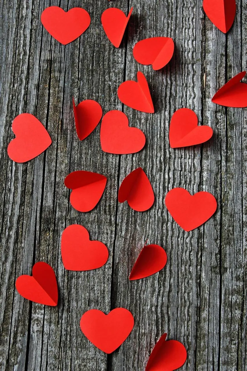 Hanging Red Hearts on Wood Showing Warm Devotion Wallpaper