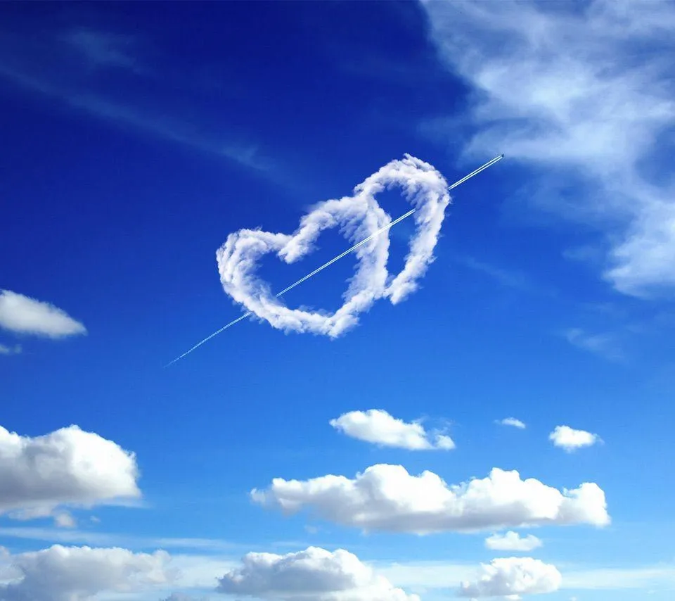 Heart Cloud in Blue Sky with Trail Symbolizing True Love