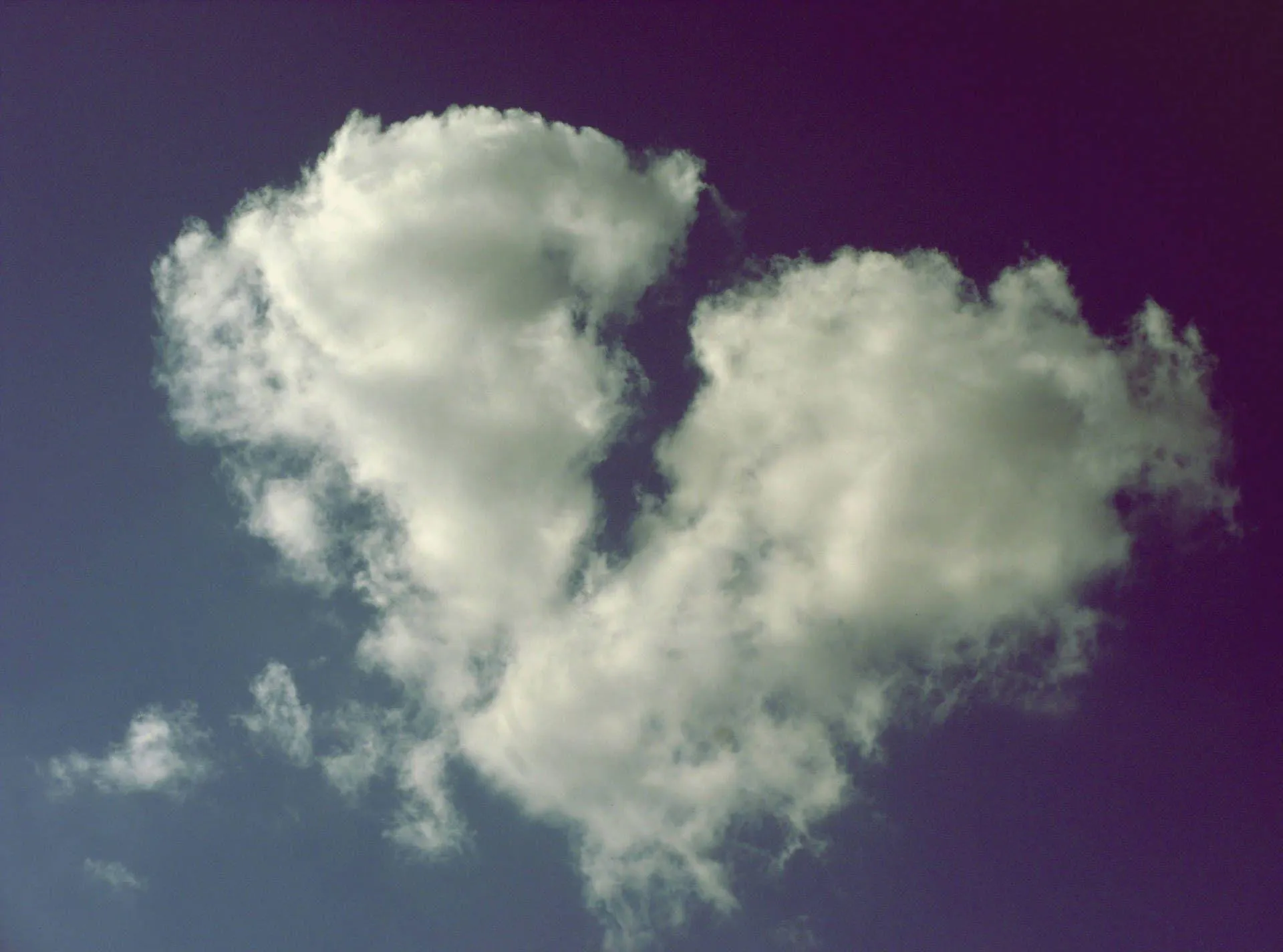 Heart Shaped Cloud Floating in Peaceful Blue Sky Wallpaper