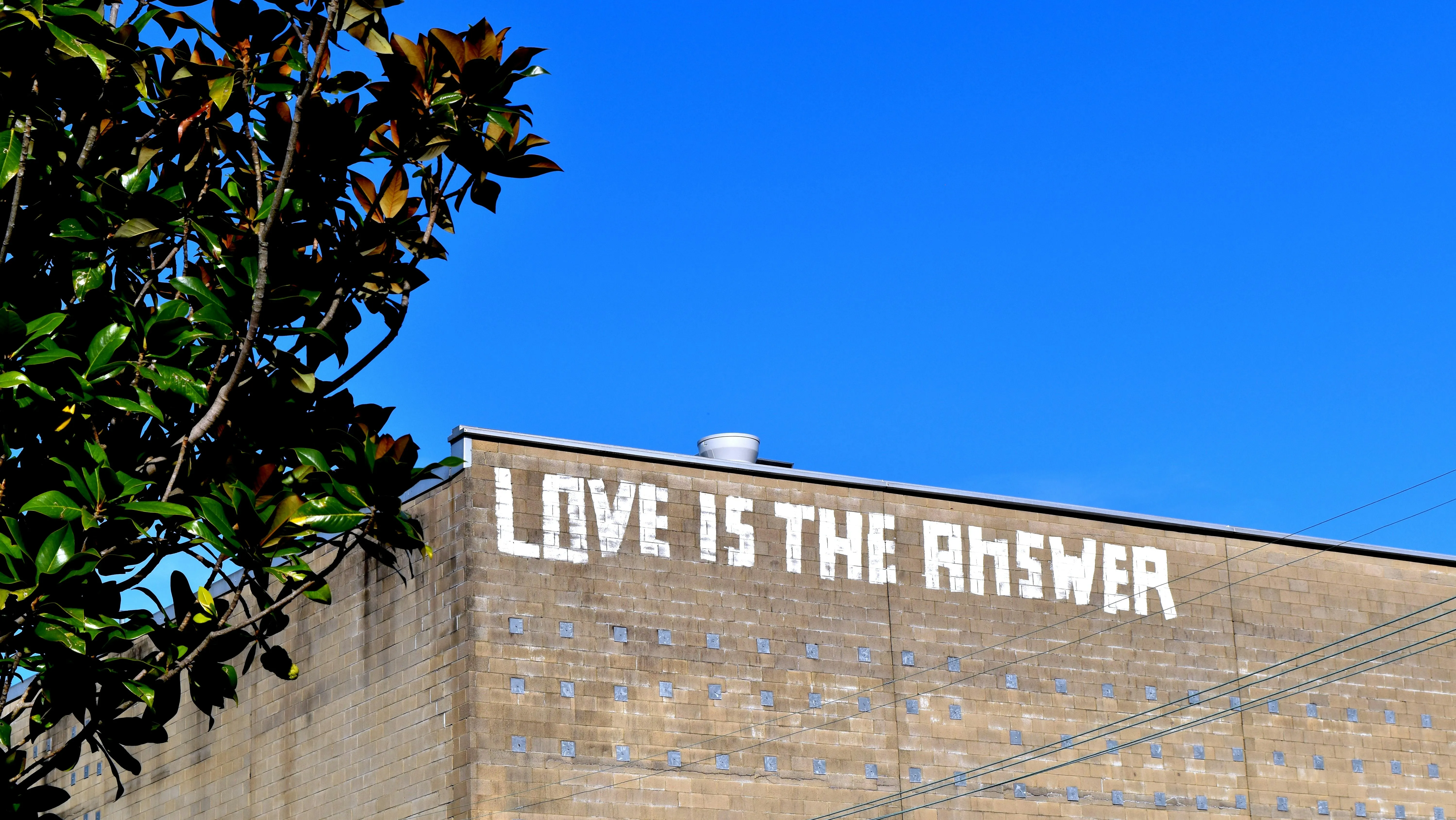 Love is the Answer Sign Spreading Message of Hope Wallpaper