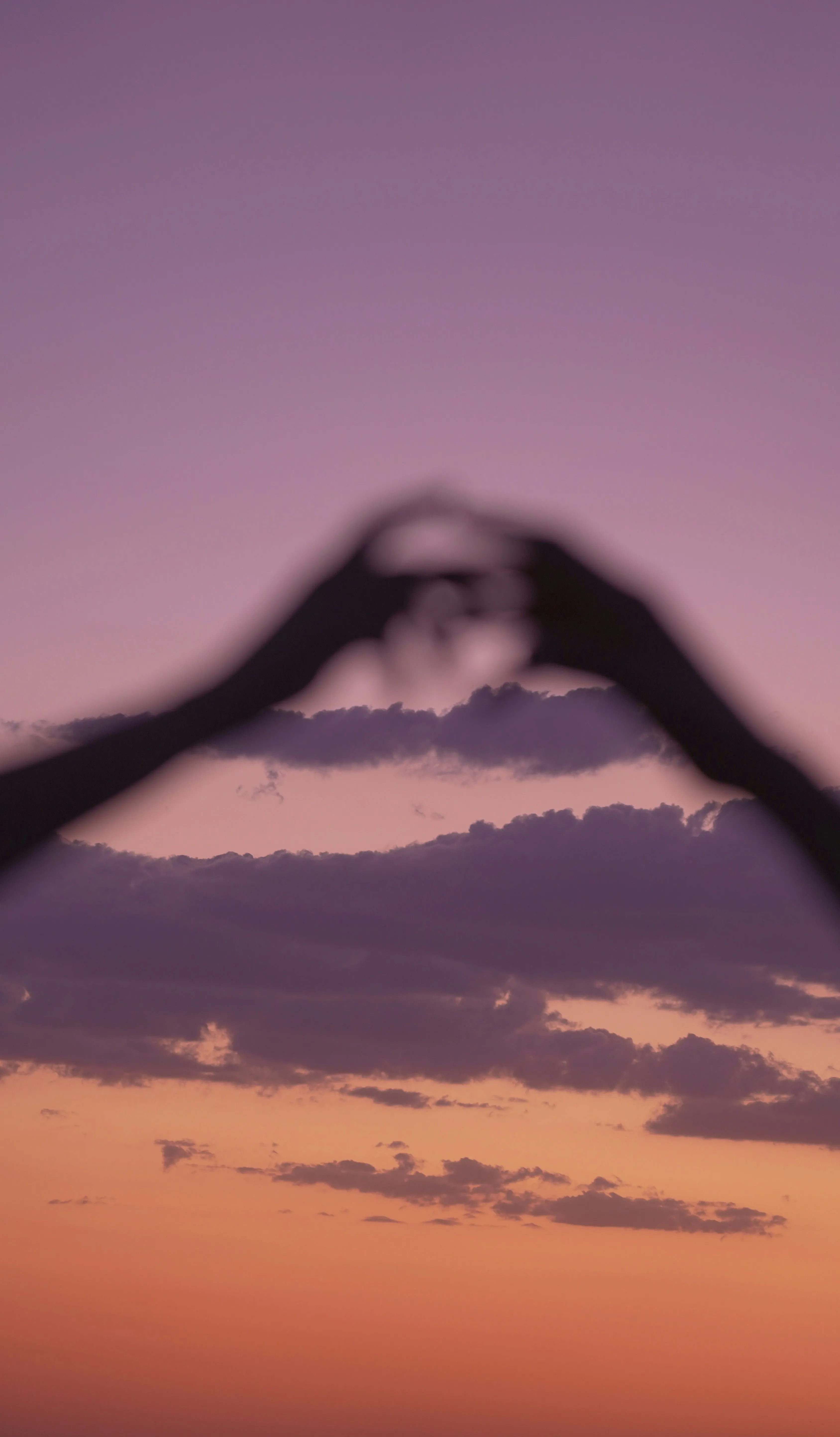 Love Symbol Created with Hands Against Beautiful Sunset